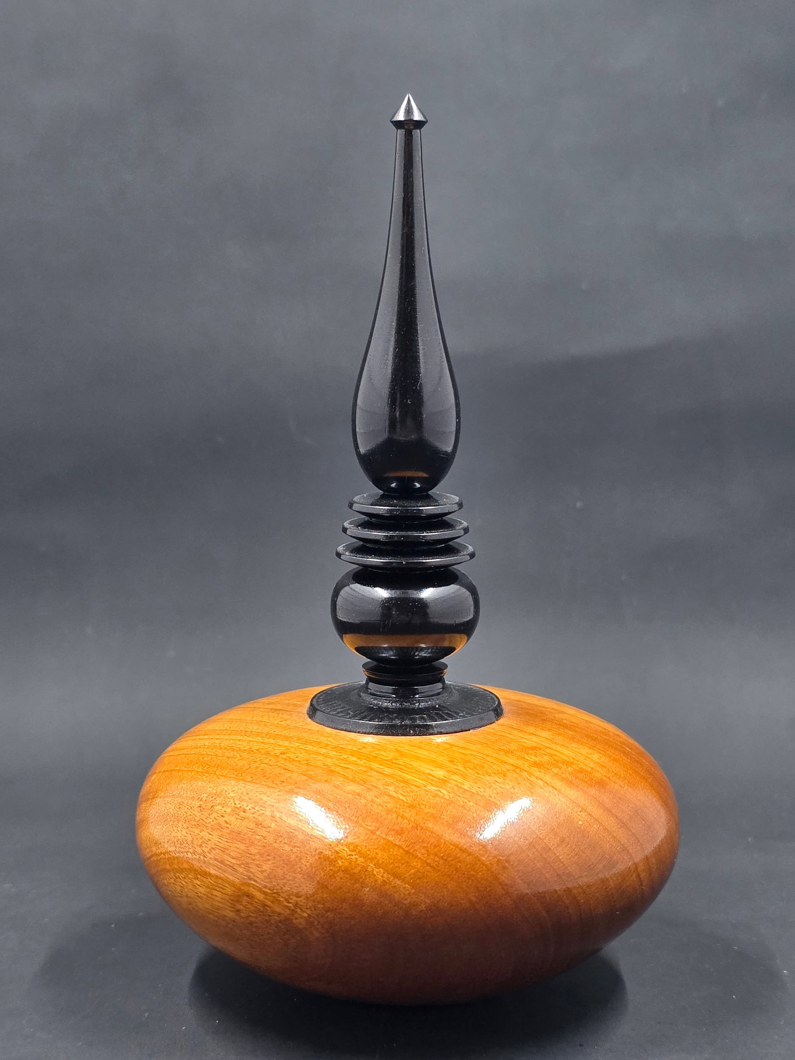 Beautifully hand turned wood and lacquered perfume bottle: A "beautifully hand-turned wood and lacquered perfume bottle" is a unique and artisanal item that combines two distinct crafts: woodworking and lacquerware. This type of object is prized for its organ
