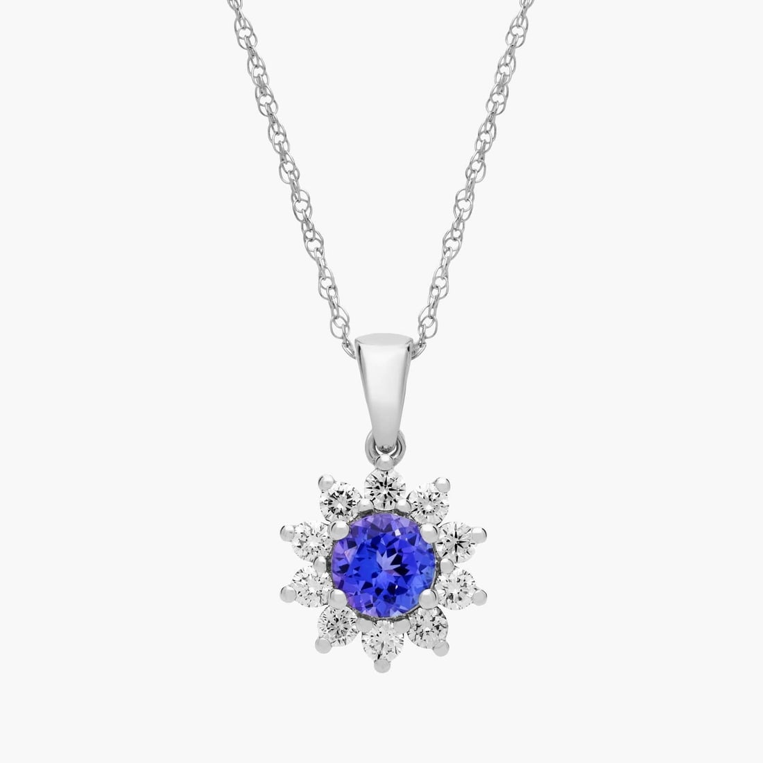 ROUND TANZANITE AND DIAMOND HALO PENDANT NECKLACE IN 14K WHITE GOLD (6MM): ROUND TANZANITE AND DIAMOND HALO PENDANT NECKLACE IN 14K WHITE GOLD (6MM)Description:A stylish round tanzanite gets added sparkle from a halo of diamonds in this 14k gold necklace. Add some color to