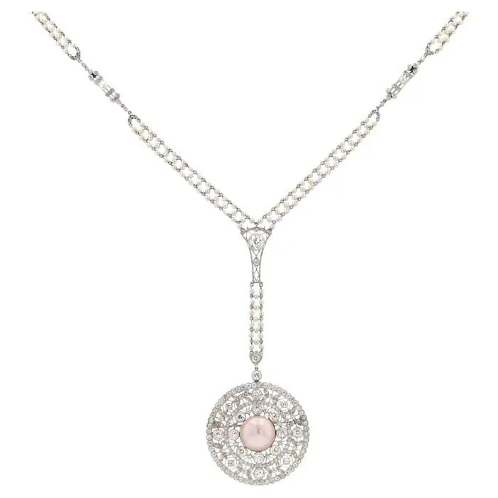 EDWARDIAN 6 CARAT DIAMOND & PEARL PLATINUM SAUTOIR CONVERSION NECKLACE: Description: This exquisite pendant exudes the charm and romance of the Edwardian era. It is elegant and captivating, with a brilliant appearance, adorned with soft and lustrous natural pearls and 6.5