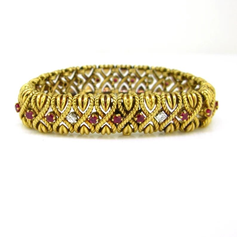 A VINTAGE RUBY: A VINTAGE RUBY Description:Using 18K gold as a base, paired with natural rubies (round cut) and diamonds (square/round cut) – the rich color of gold forms a striking contrast with the bright red of