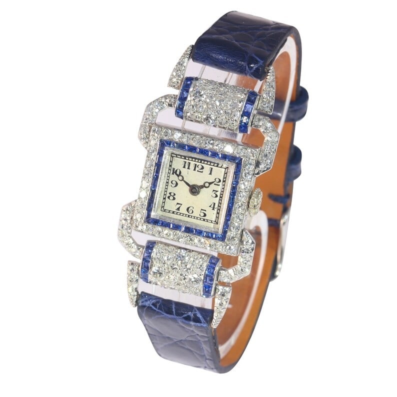 ANTIQUE WATCH WITH FULL DIAMOND AND SAPPHIRE CRYSTALS, DATING FROM THE MID-20TH CENTURY ART DECO: ANTIQUE WATCH WITH FULL DIAMOND AND SAPPHIRE CRYSTALS, DATING FROM THE MID-20TH CENTURY ART DECO STYLE. Description: Crafted in platinum/18K white gold with full diamond and sapphire settings, the cas