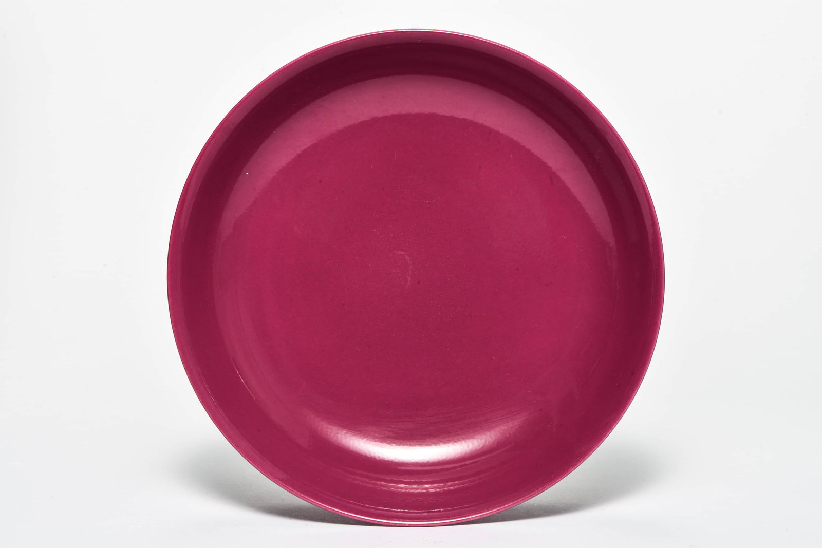 A RUBY-RED GLAZED DISH: A RUBY-RED GLAZED DISHDescription:Diameter: 21.5 cm Height: 4.5 cm