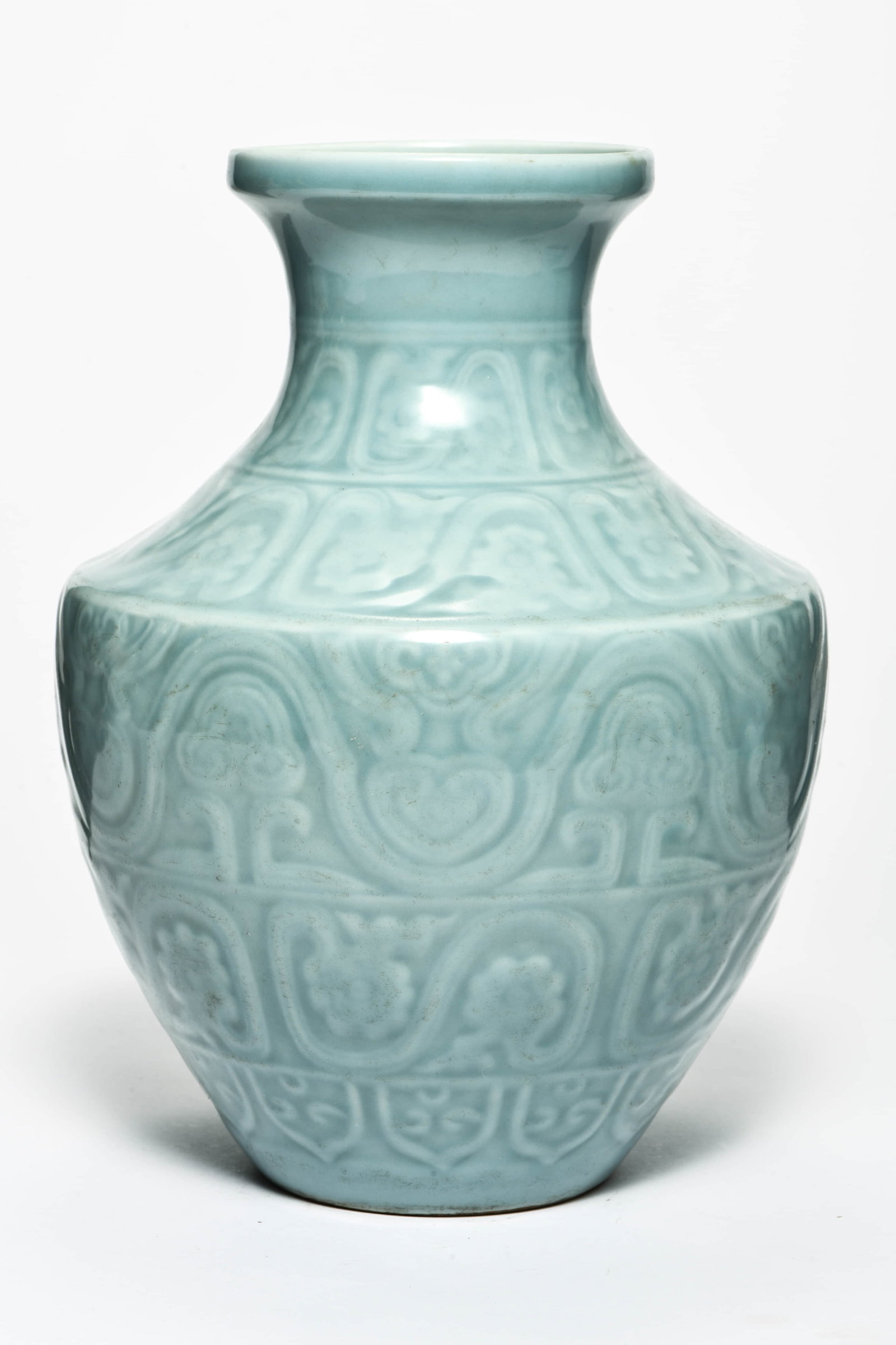 A PALE CELADON GLAZED RELIEF 'EIGHT BUDDHIST EMBLEMS' VASE: A PALE CELADON GLAZED RELIEF 'EIGHT BUDDHIST EMBLEMS' VASEDescription:Length: 20cm Width: 20cm Height: 31cm