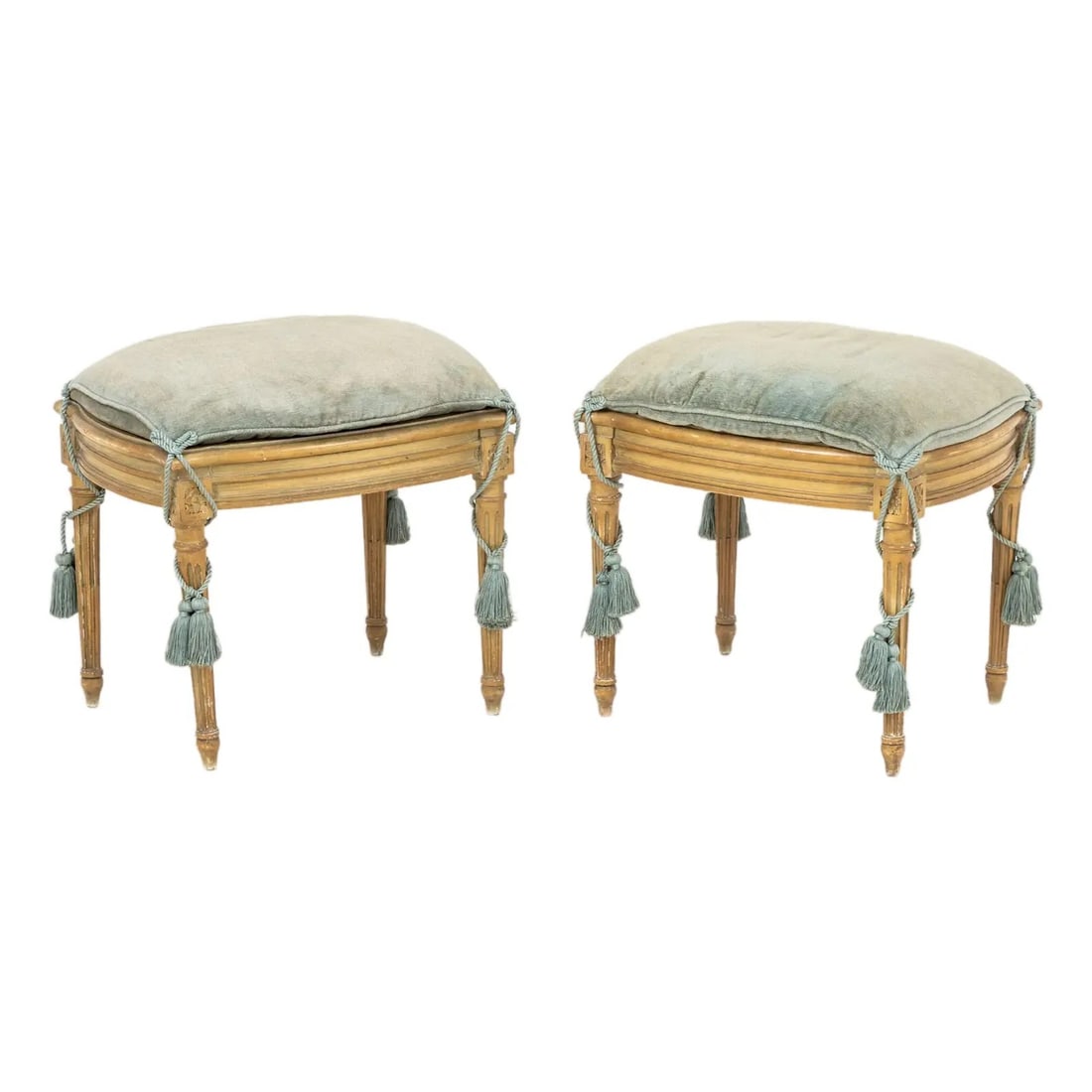 PAIR OF LOUIS XVI STYLE GILTWOOD STOOLS WITH TASSEL-TIED UPHOLSTERY: PAIR OF LOUIS XVI STYLE GILTWOOD STOOLS WITH TASSEL-TIED UPHOLSTERYDescription:The pair features a classic rectangular seat frame with softly rounded corners, carved in wood and finished in a warm