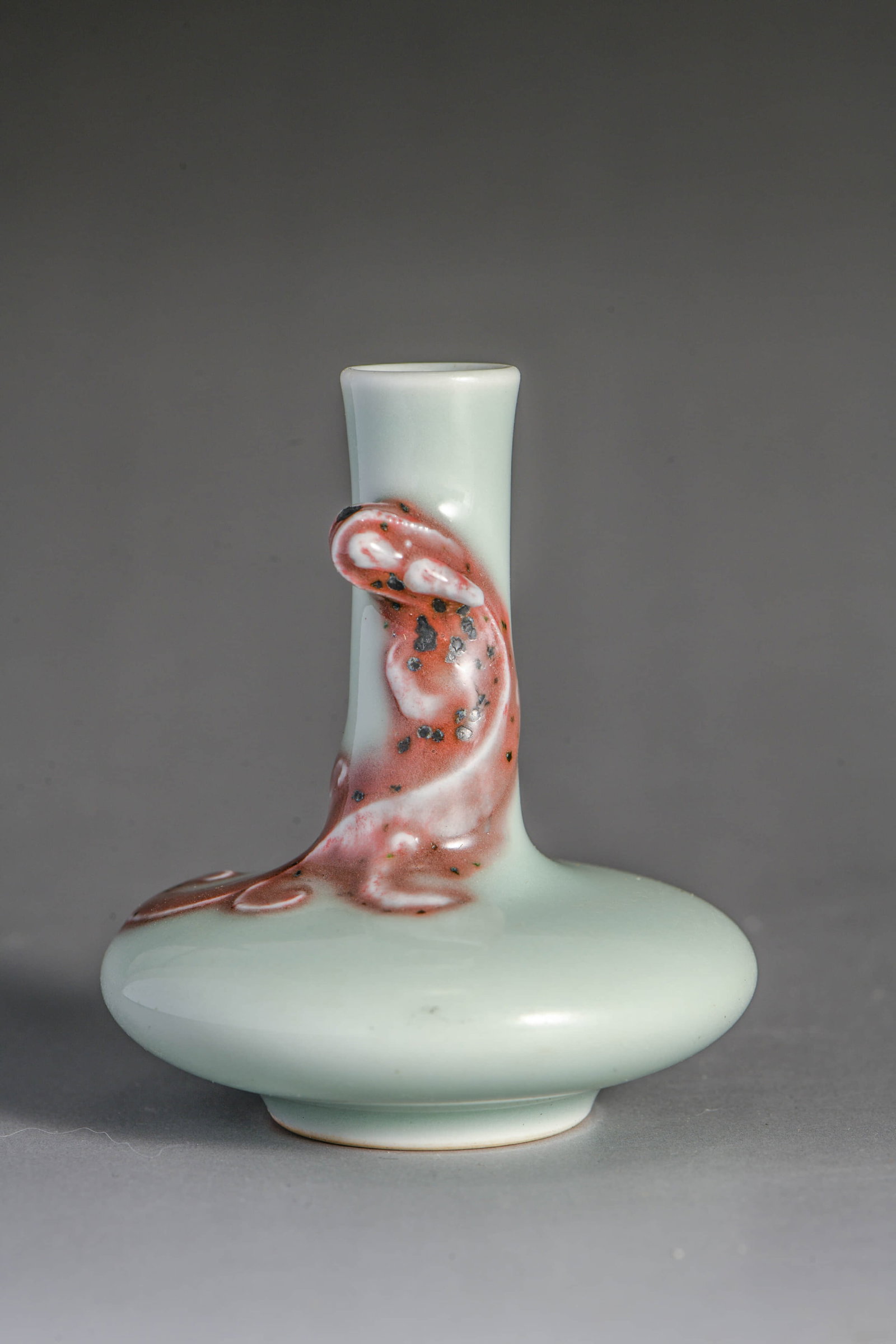 A PALE CELADON-GLAZED 'DRAGON' VASE: A PALE CELADON-GLAZED 'DRAGON' VASE Description: Model: Made in the Qianlong Dynasty Width: 6.5 cm x Height: 7 cm
