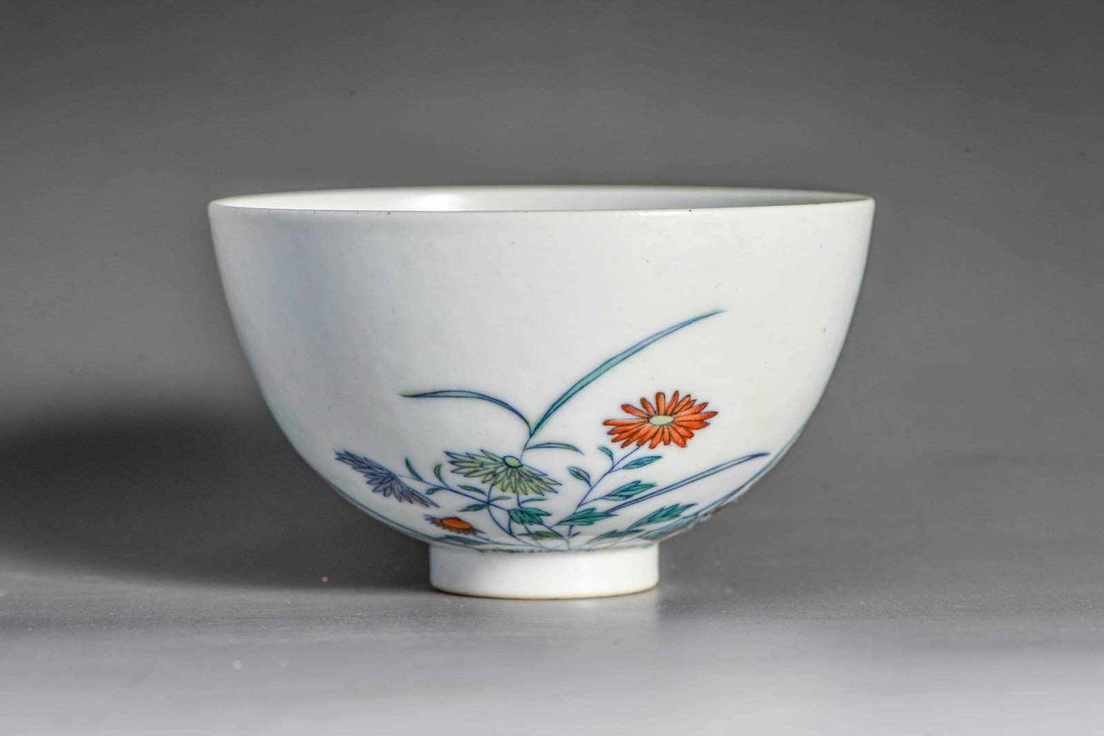 A DOUCAI 'FLOWERS AND POETRY' CUP: A DOUCAI 'FLOWERS AND POETRY' CUP Description: Description: Made in the year of the Qianlong reign of the Qing Dynasty Width: 9.5 cm x Height: 5.5 cm