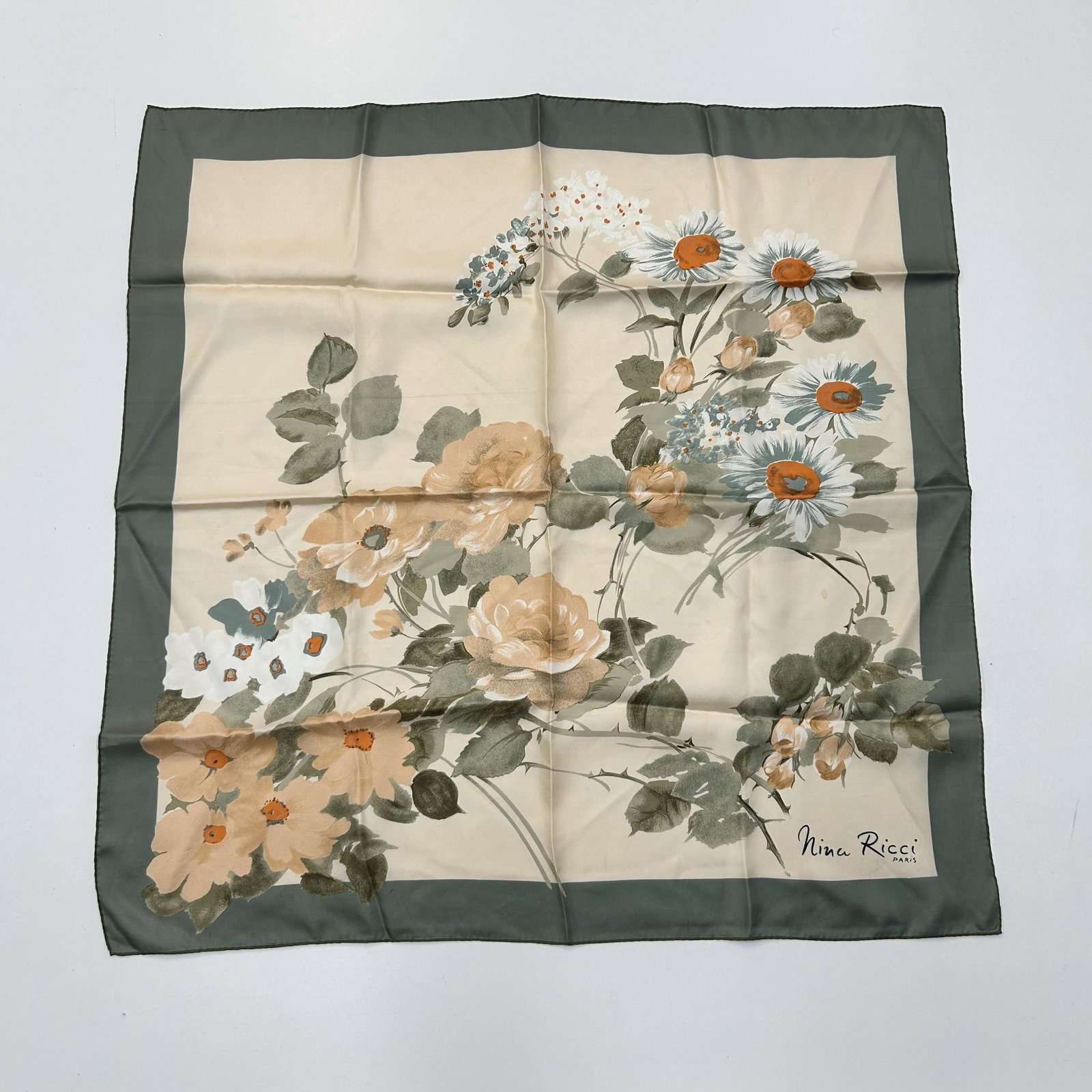 Nina Ricci Flowers Hand Rolled Silk Scarf Made in France: This stunning vintage Nina Ricci hand rolled silk scarf is a luxurious accessory made in France. The multi-color design adds a touch of elegance to any outfit, making it a versatile piece for both