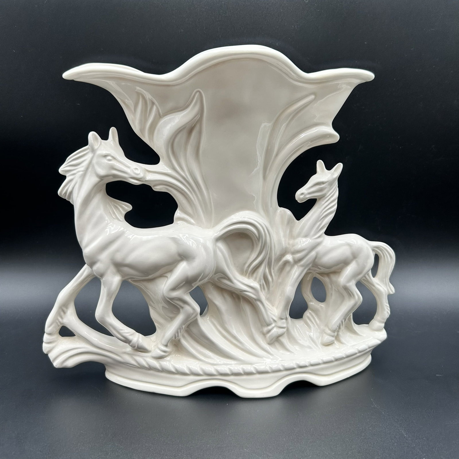 MCM White Vase with Prancing Horses: This Mid-Century Modern white glaze finished vase with prancing horses is signed Janet Colton 1978. The vase is in great condition with no chips or cracks.