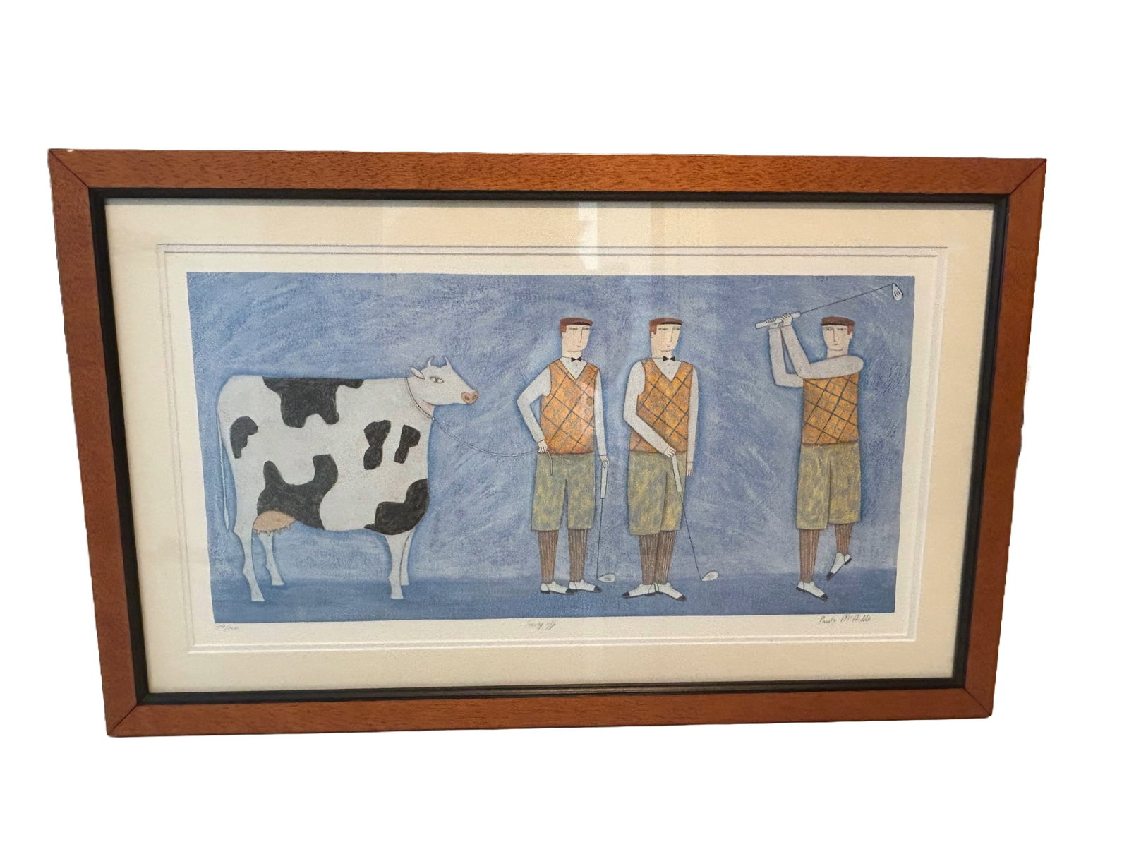 "Teeing Off" by Paula McArdle: Framed serigaph print titled "Teeing Off" by artist Paula McArdle. Paula McArdle is known for her Naive art style, which often features whimsical and childlike depictions of everyday life and sporting