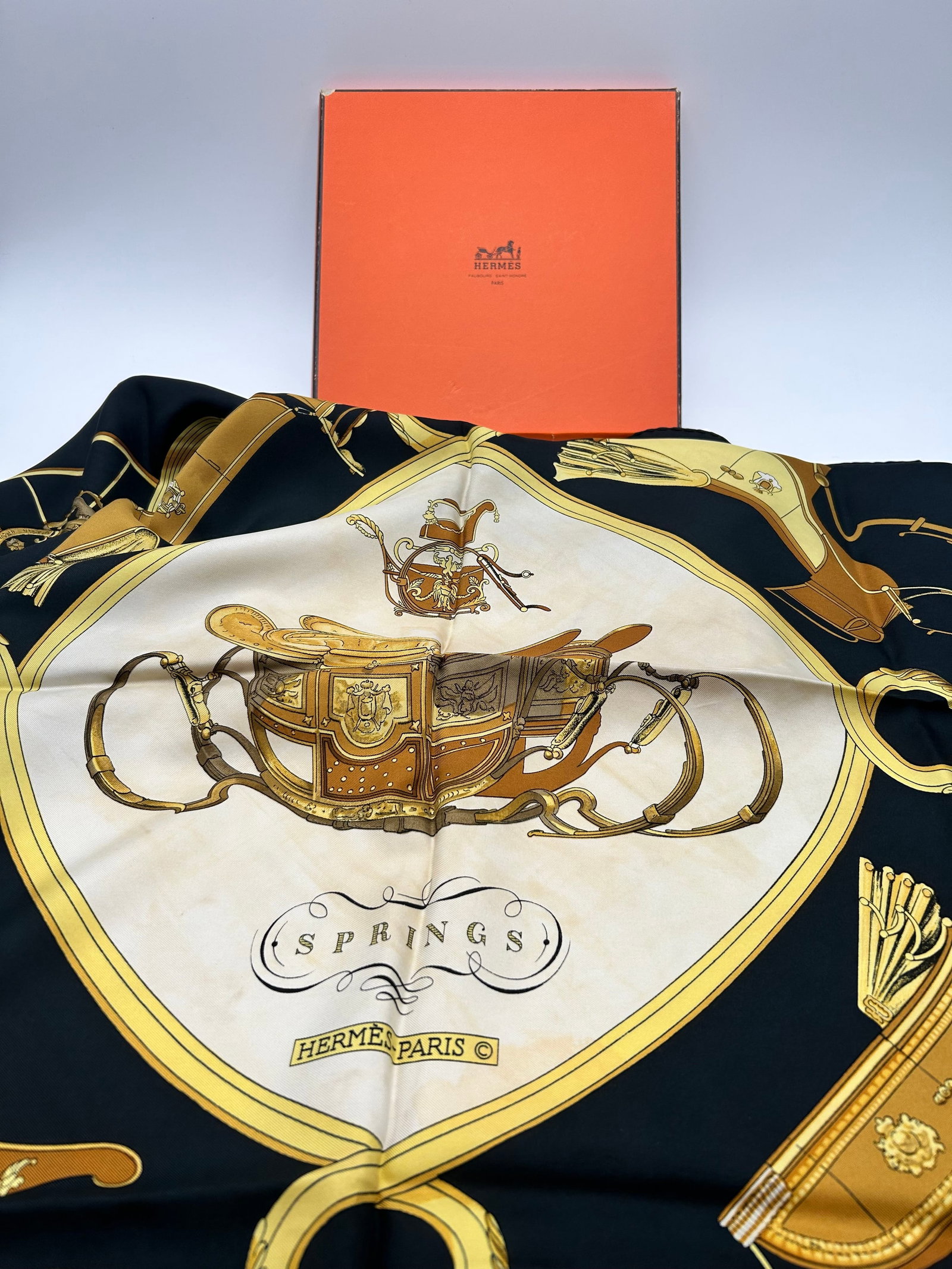 Vintage 1980s HERMES Paris Black Spring Silk Scarf Made in France: This is a vintage 1980s HERMES Paris black silk scarf, featuring a square design with a horse-related theme. Made in France, the versatile scarf can be worn in various ways and is crafted from high-qu