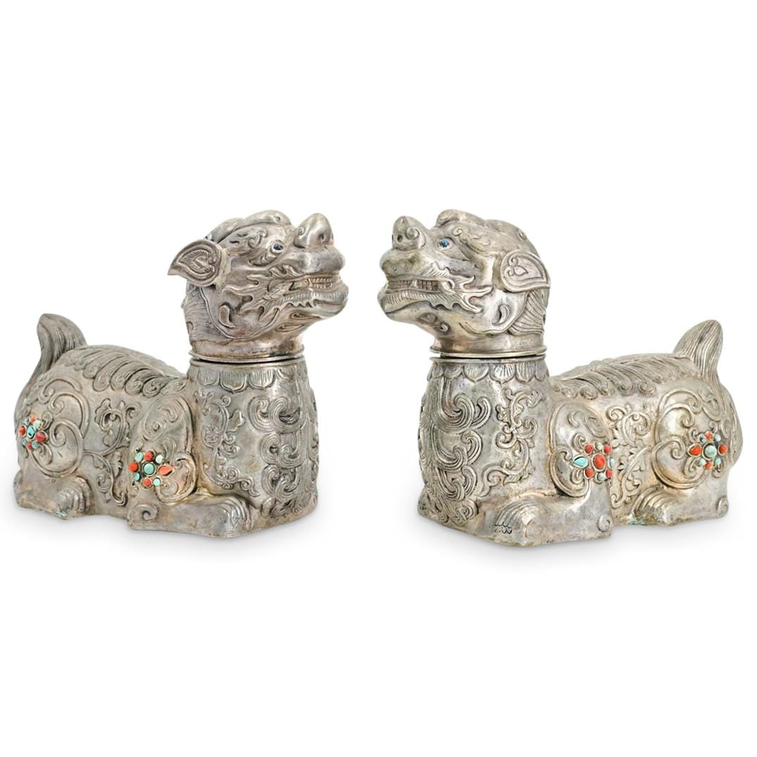 Pair Of Mongolian Silver, Turquoise, and Coral Lions: Two matching silver recumbent lions, each featuring curled and finely fashioned hair and embellished with coral and turquoise beads on its shoulders and haunches. Each piece's head is removable.
