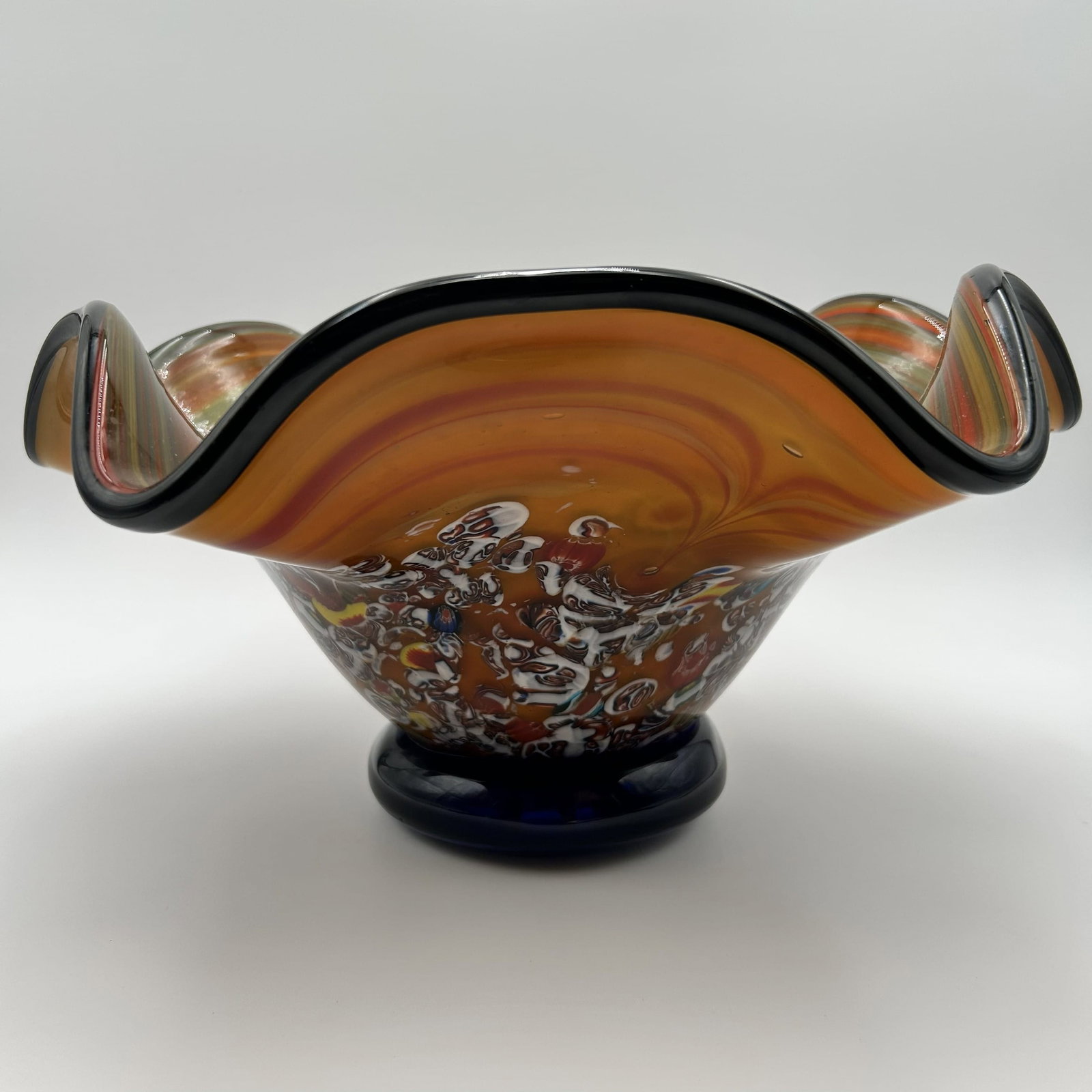 Vintage Hand Blown Millefiori Art Glass Centerpiece Pedestal Bowl: This stunning vintage hand blown Millefiori Art Glass center piece pedestal, features a vibrant, multicolored design with a wavy, ruffled edge. It is crafted using traditional Italian glass-making tec