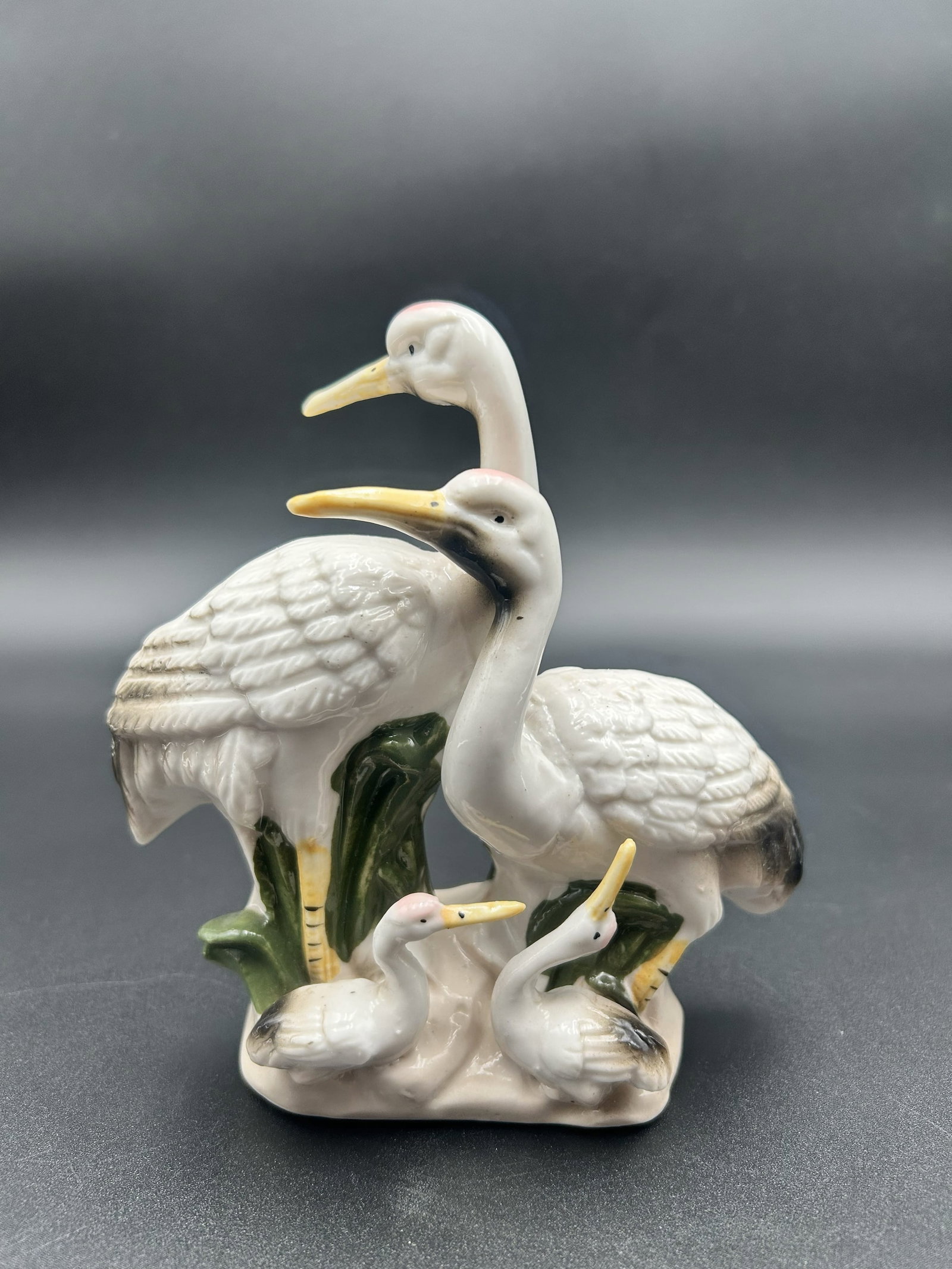Porcelain Statuette of Four White Birds: This lot is for a very delicate porcelain statuette of four white birds, what looks like the parents and chicks. Nice addition to any bird or vintage collection.