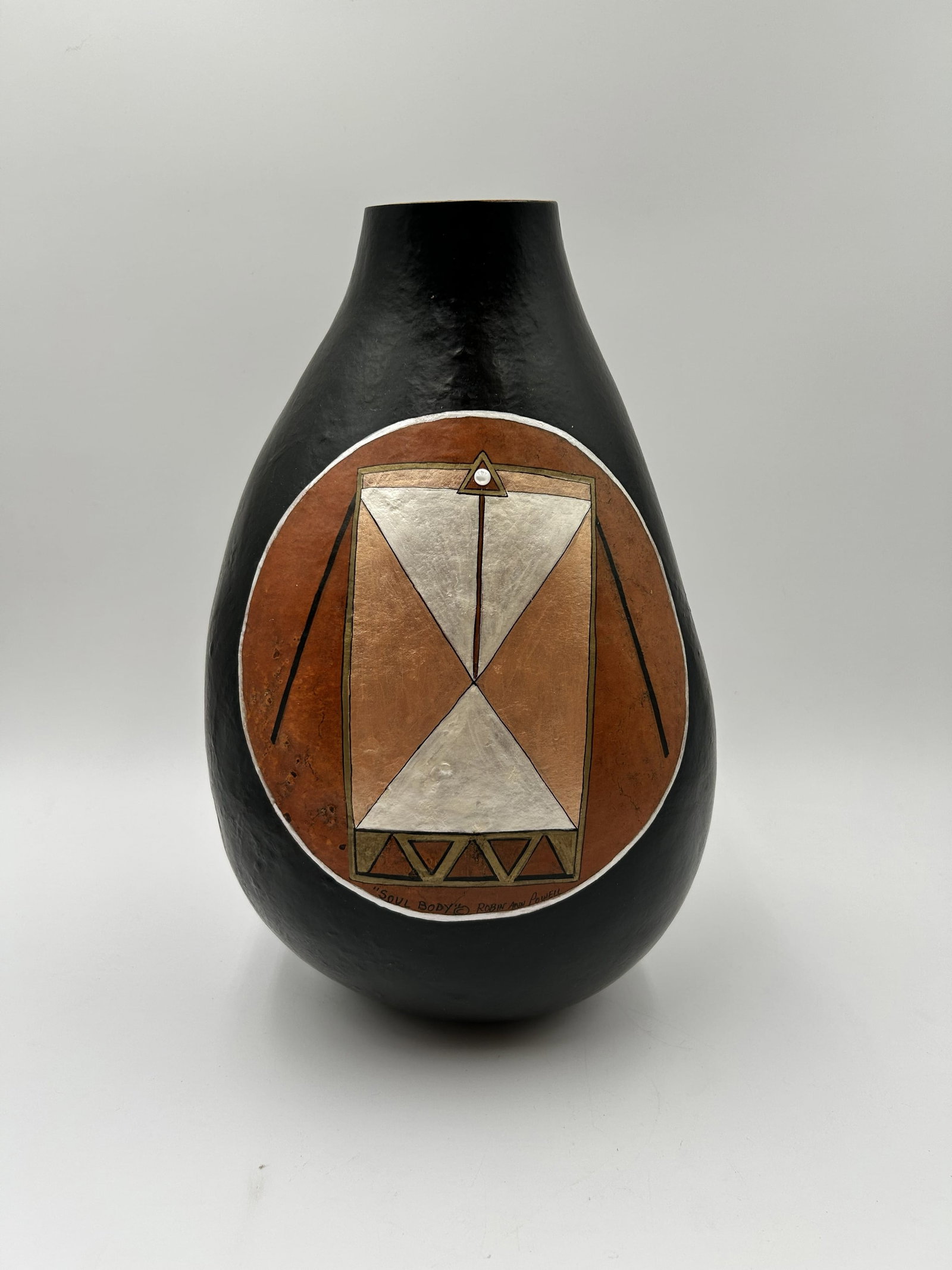 "Soul Body" Gourd Vase by Robin Ann Powell: The "Soul Body" Vase is a hand-painted gourd vase by artist Robin Ann Powell. This piece features Southwestern-inspired fine art with gold, black, and terracotta tones on a natural gourd.Dimensions -