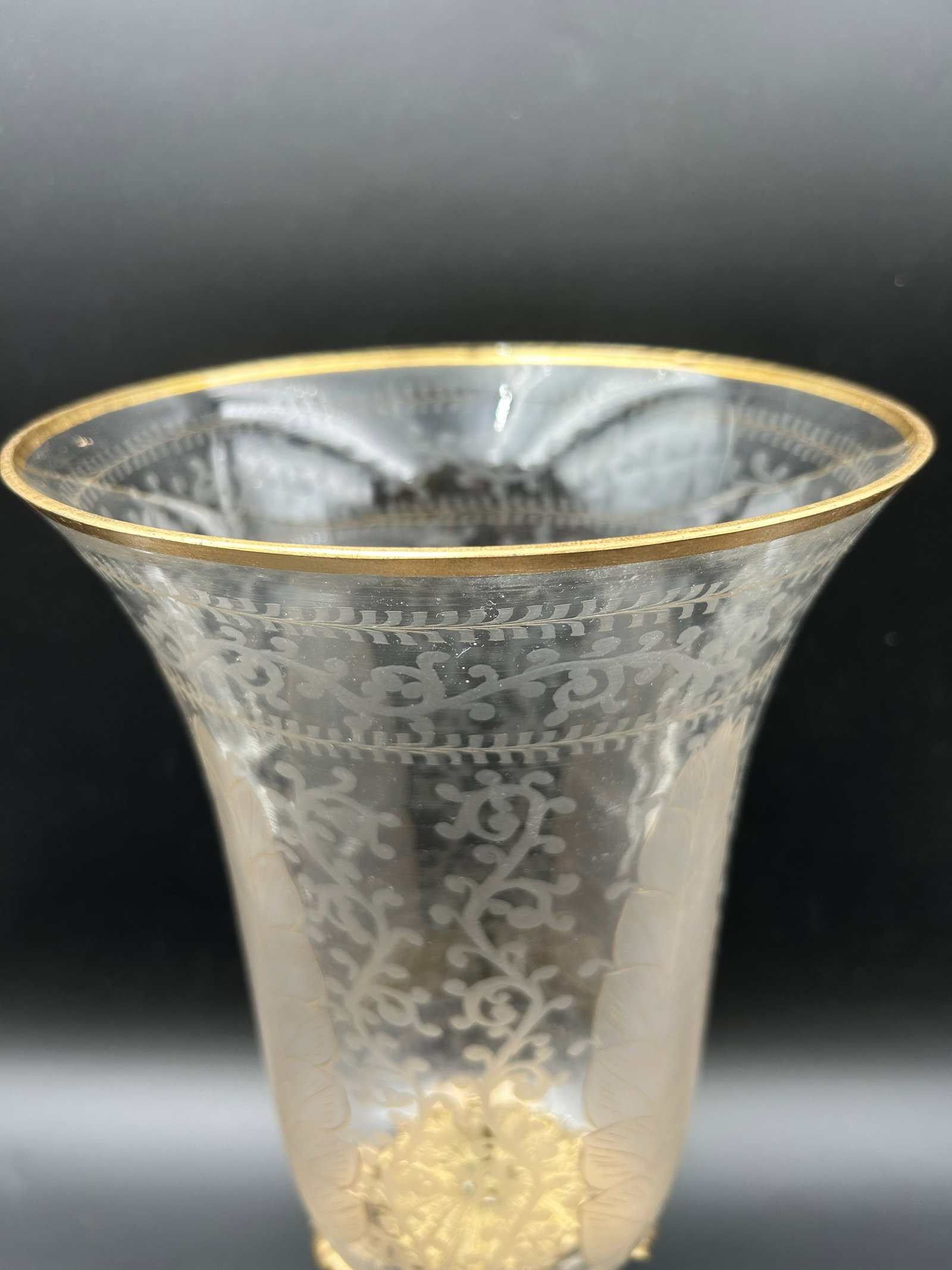 Goa Candle Stand: This is a Goa candle stand featuring a hand-etched glass shade and a brass base with an antique patina. The rim of the shade is accented with gold leaf. Solid brass tripod base features classically in