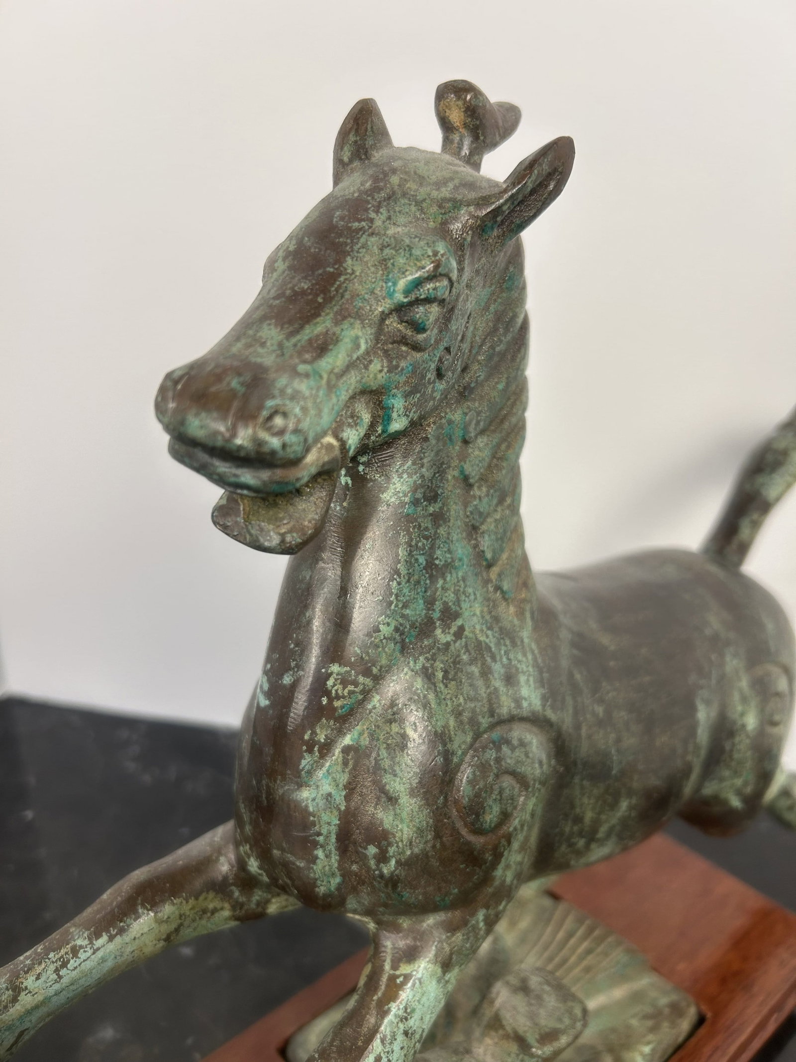 Verdigris Finish Bronze Horse Sculpture on Wood Base: Very heavy verdigris finish bronze horse sculpture. Horse trots on a peak and is captured mid gallop with birds holding on. The bronze has a lovely worn patina in a verdigris fashion. Sculpture is in 
