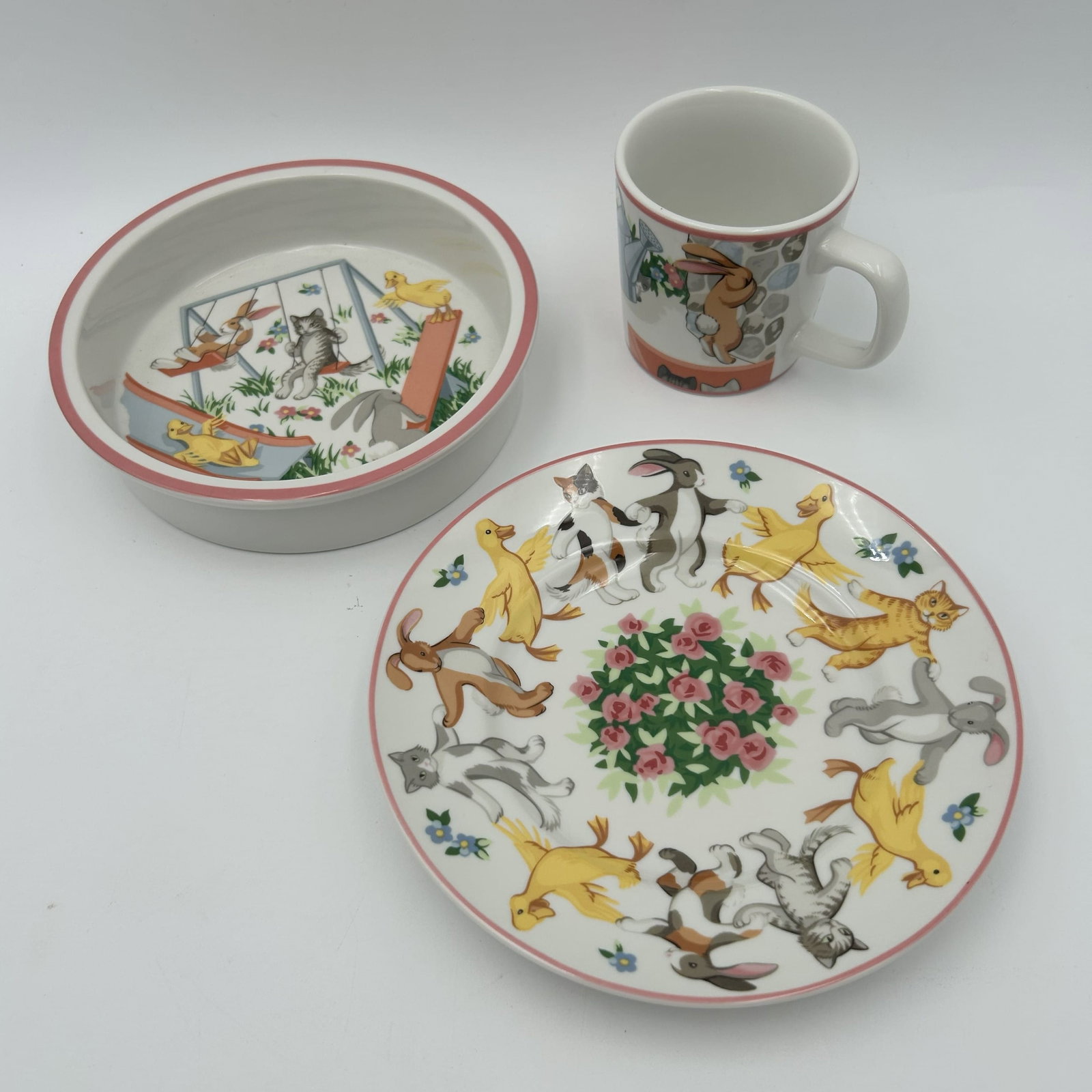 Vintage 1992 Tiffany & Co. Playground 3-Piece Child's Porcelain Set: This lot is for a vintage 1992 Tiffany & Co. Playground 3-piece child's porcelain set featuring whimsical illustrations of bunnies, kittens, and ducks with a pink trim. The discontinued set includes