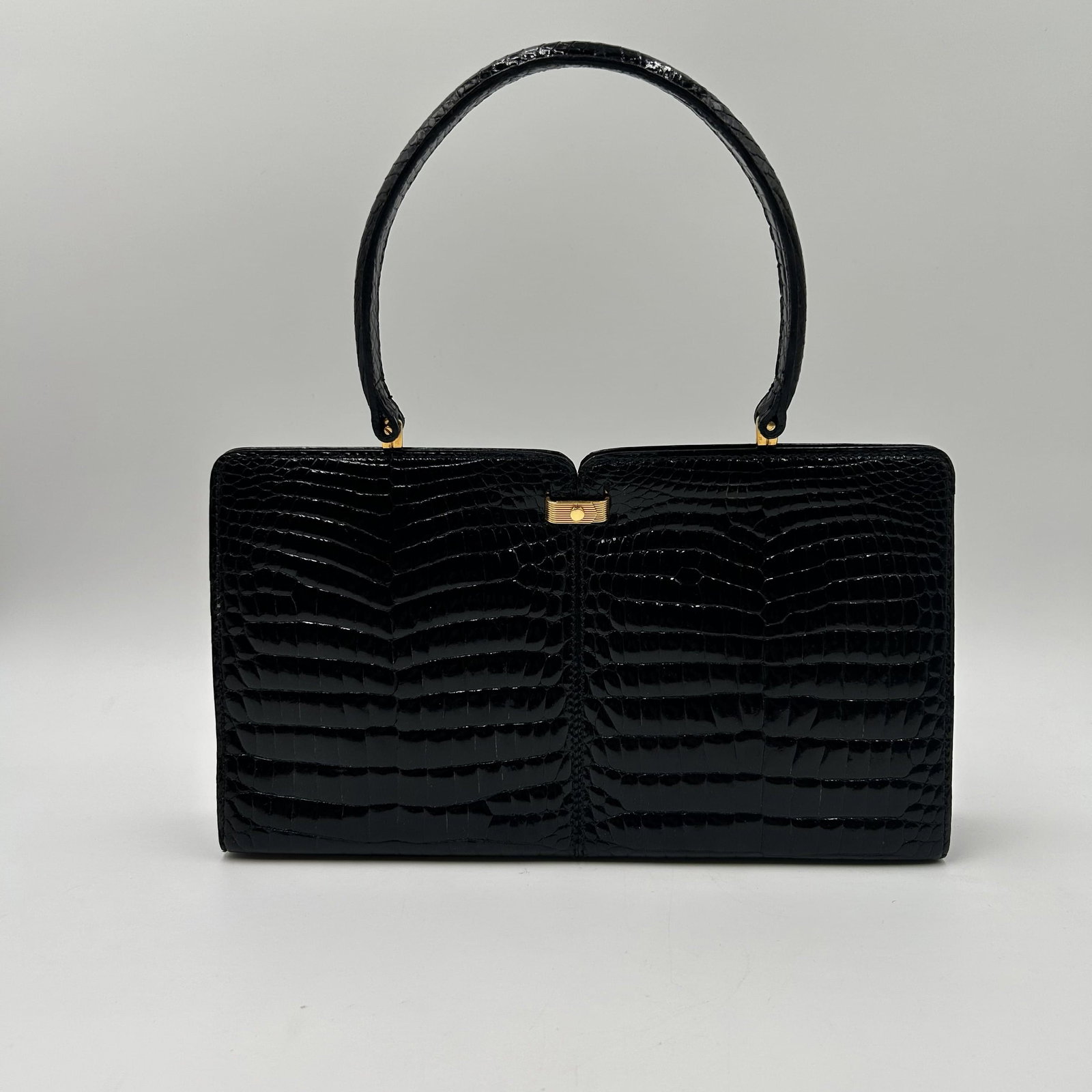 Vintage Black GOYARD Crocodile Handbag, Clutch, from the 60s: This lot is for a black GOYARD brand vintage crocodile embossed leather handbag, clutch, from the 60s. Dimensions - 12 1/2" W x 2 1/4" D x 7" H At handle - 13 1/2" H No cracks or damage to the handle 