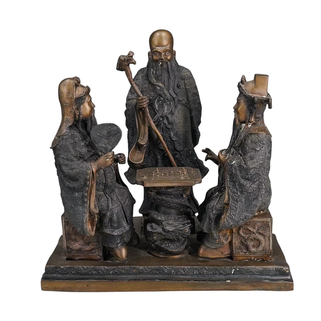 Antique Chinese Bronze Sanxing Xiangqi Statue: Antique bronze sculpture depicting Shou, the god of longevity, watching Lu and Fu, the gods of prosperity and good fortune (respectively), seated at game of Xianqi ("Chinese Chess") on a dragon form t