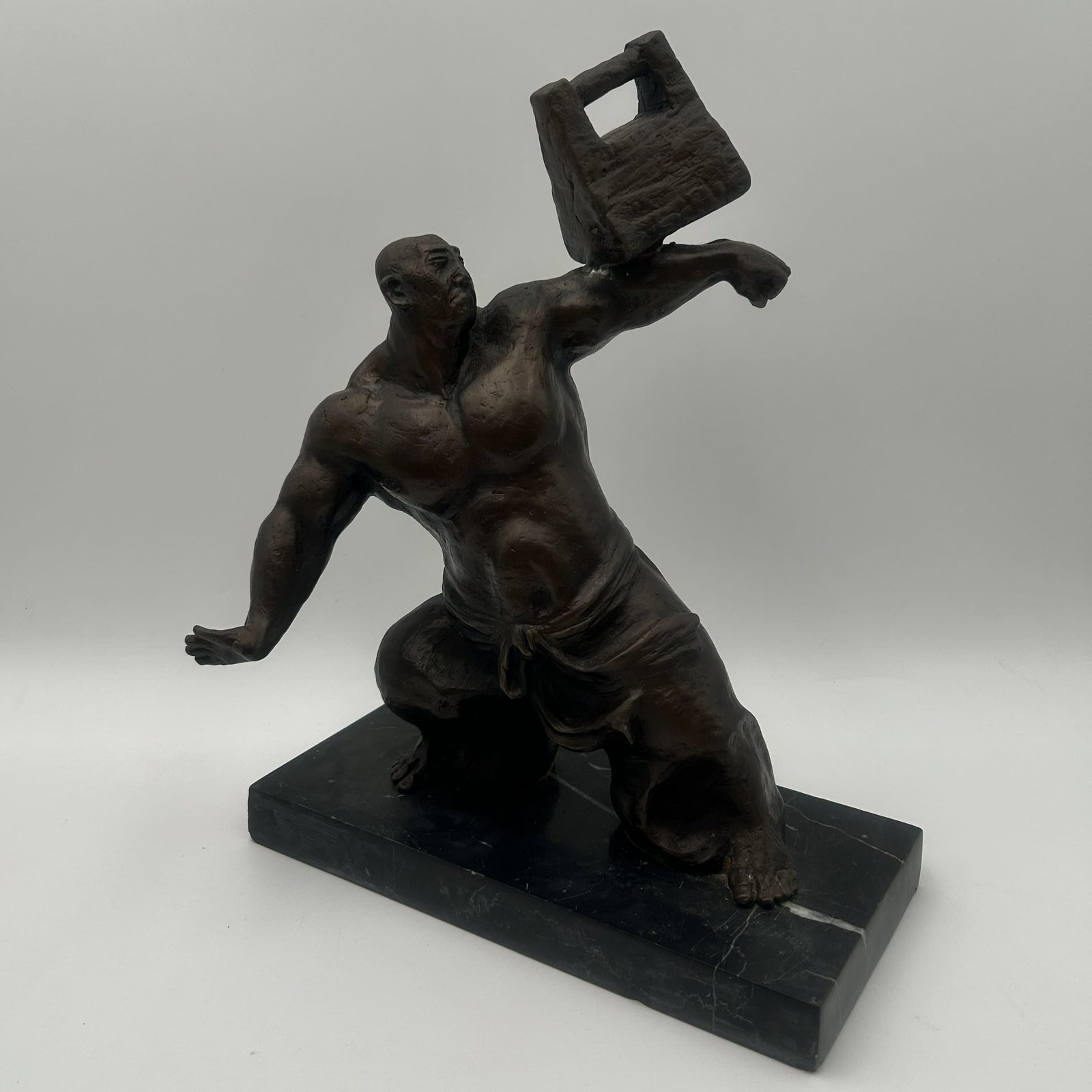 "Tai Chi Master Balancing Weight" Bronze Sculpture: This is a bronze sculpture titled "Tai Chi Master Balancing Weight" (or Shaolin Monk Practicing Tai Chi with Stone Lock), mounted on a black marble base. This sculpture is in great condition. Dimensio