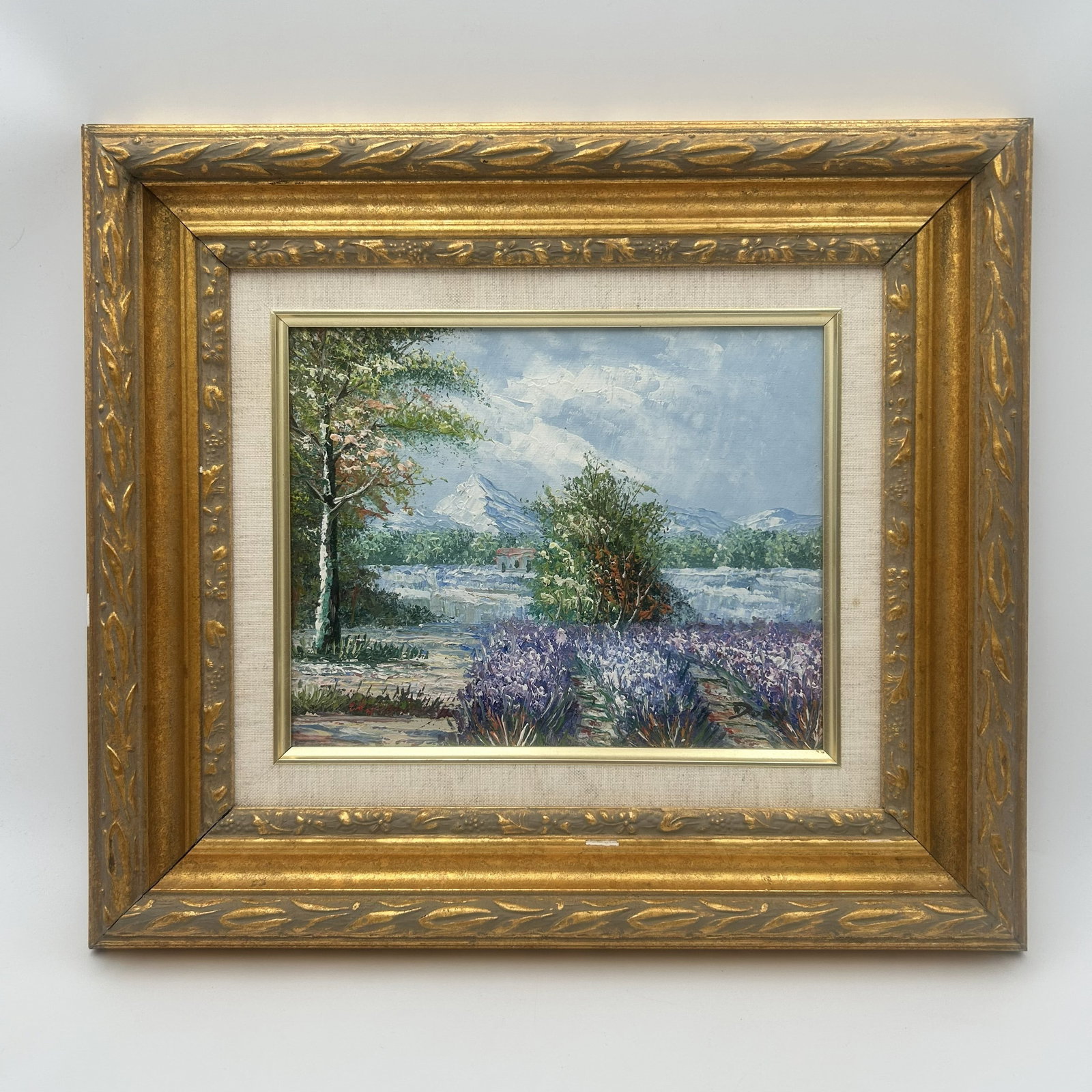 Oil Painting of Vibrant Provencal Landscape: This listing is an oil painting which captures a vibrant Provencal landscape featuring a field of blooming purple lavender in the foreground and distant mountains under a cloudy sky. Nice vintage fram