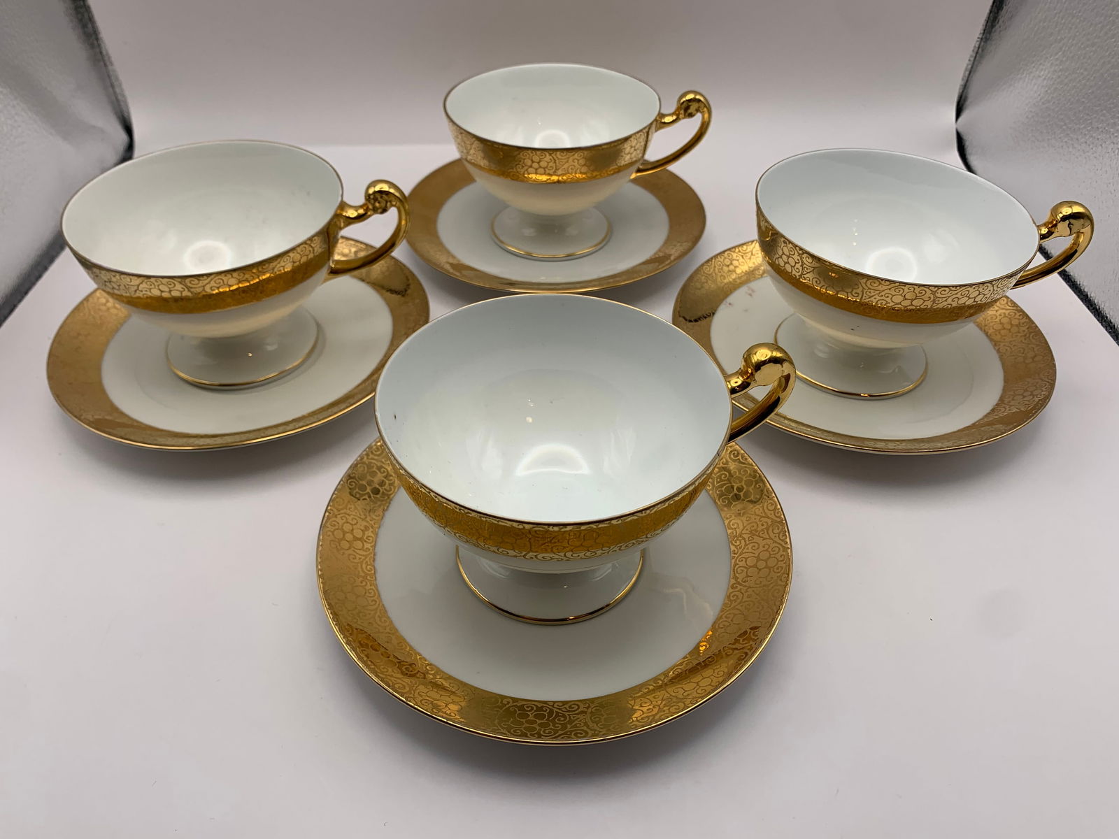 Bavaria Porcelain Creamer, Tea Cups, & Saucers: Set of one 18k gilded porcelain creamer & four gilded tea cups and saucers from Bavaria Porcelain.