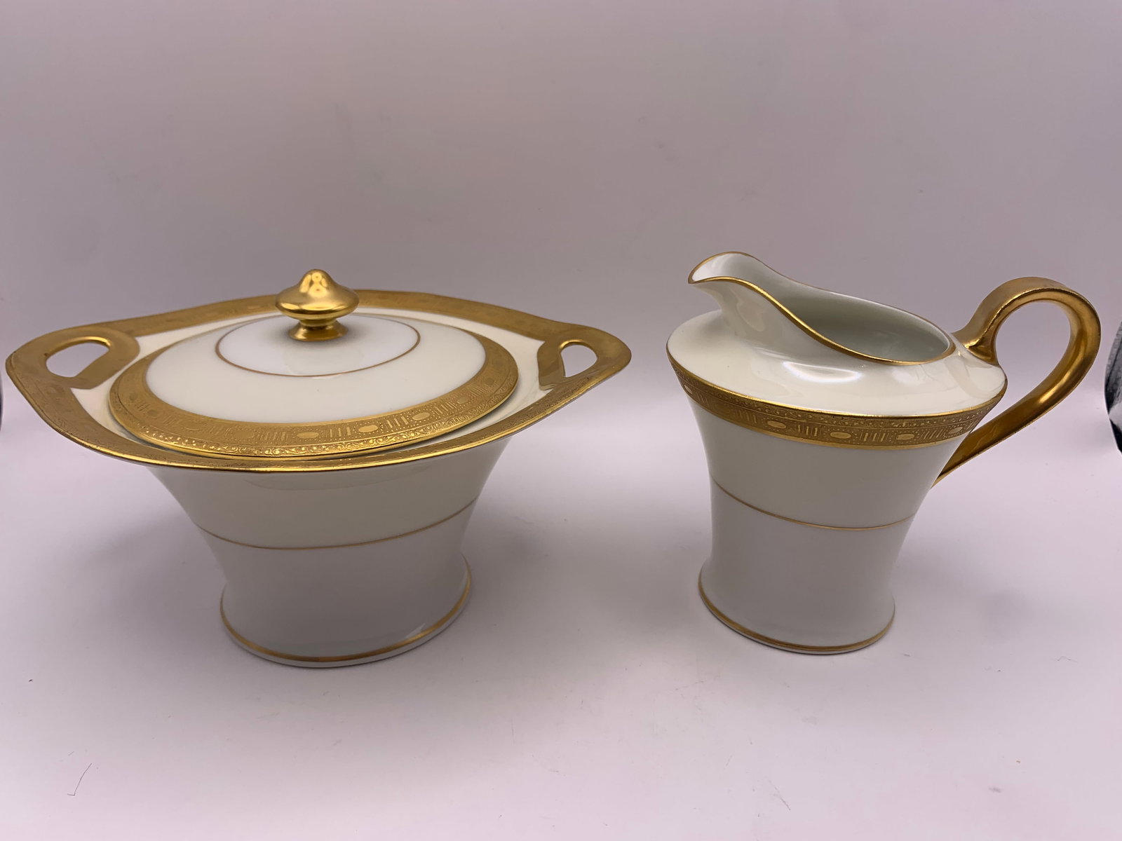 Limoges Sugar Bowl & Creamer: A porcelain sugar bowl & creamer with gilded edges from Limoges.