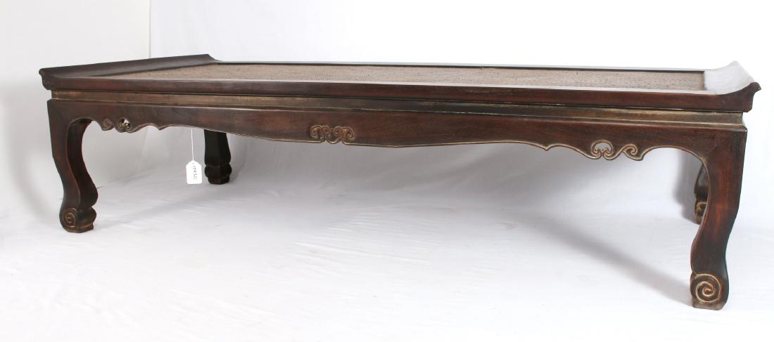 ZITAN DAY BED: Zitan Day Bed: Zitan day bed with a caned seating area, carved and scalloped edge, and scrolled feet. 79 1/2" X 35 1/4" X 20 1/2" $1000 - $150