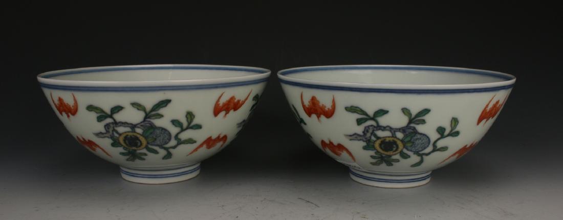 PAIR OF DOU CAI BAT BOWLS: Pair Of Dou Cai Bat Bowls: Bats alternate with fruit along the outside of the bowls, while the interior is divided between bats flying over water and bats encircling a peach tree. Six character mark