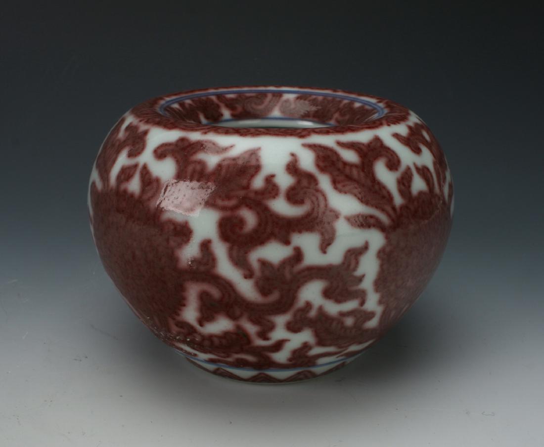RED AND WHITE BRUSH WASHER: Red And White Brush Washer: A brush washer decorated in red oxide and cobalt, the top curves down toward the interior. Large flowers repeat around the center of the brush washer over a repeat triangu