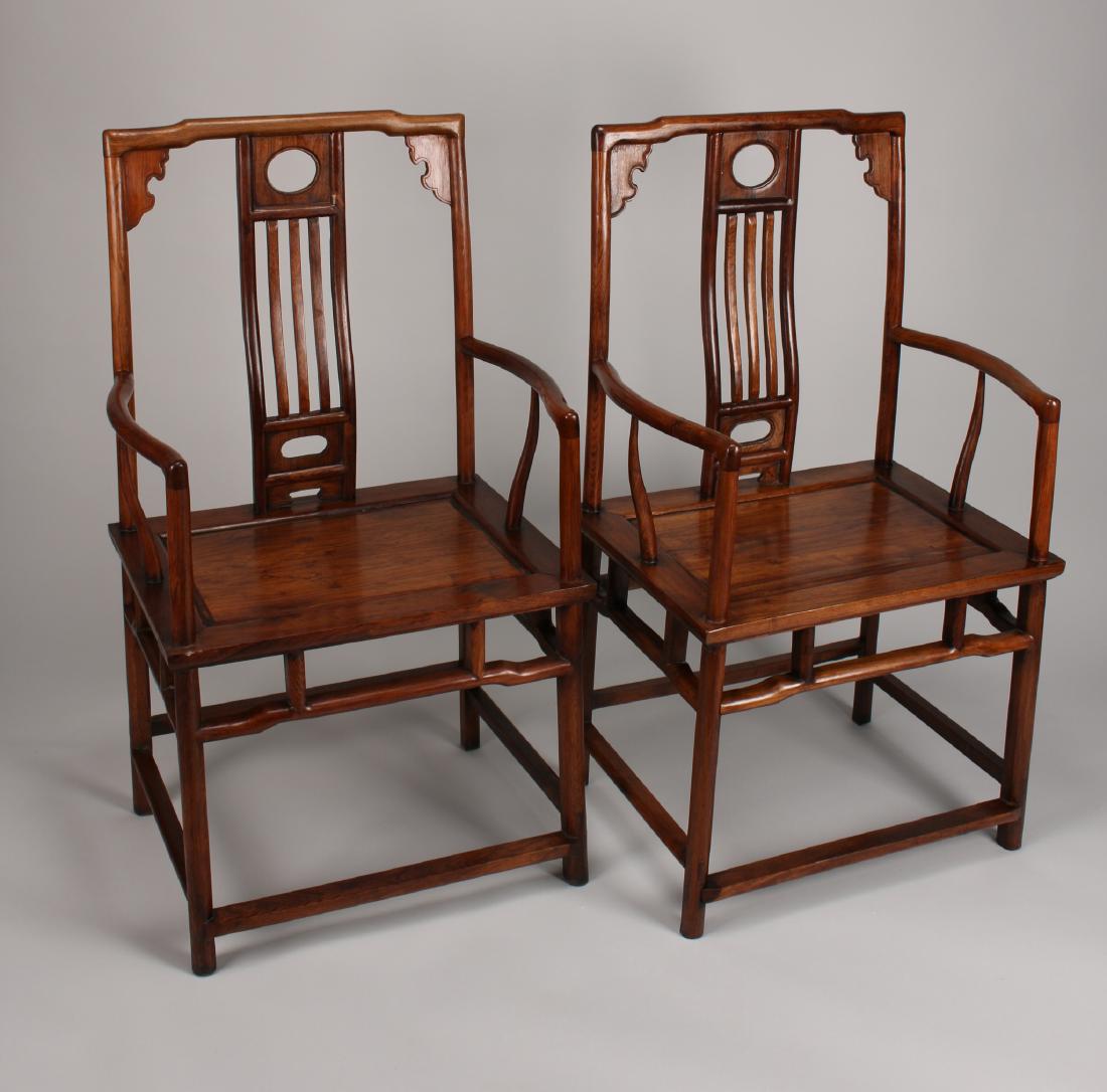 PAIR OF HUANGHALI ARM CHAIRS: Pair Of Huanghali Arm Chairs: Paneled seats, teardrop shaped legs, beaded and scalloped corners, very highly figured, and mortise and tenon construction. 18" X 23 1/2&
