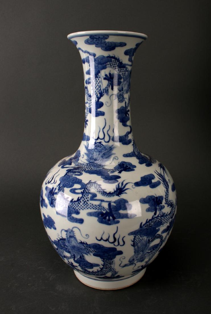BLUE AND WHITE DRAGON VASE: Blue And White Dragon Vase: A blue and white globular vase with dragons and flaming pearls. Swirling dragons cover every surface. Six Character mark on the bottom. 14 3/4&