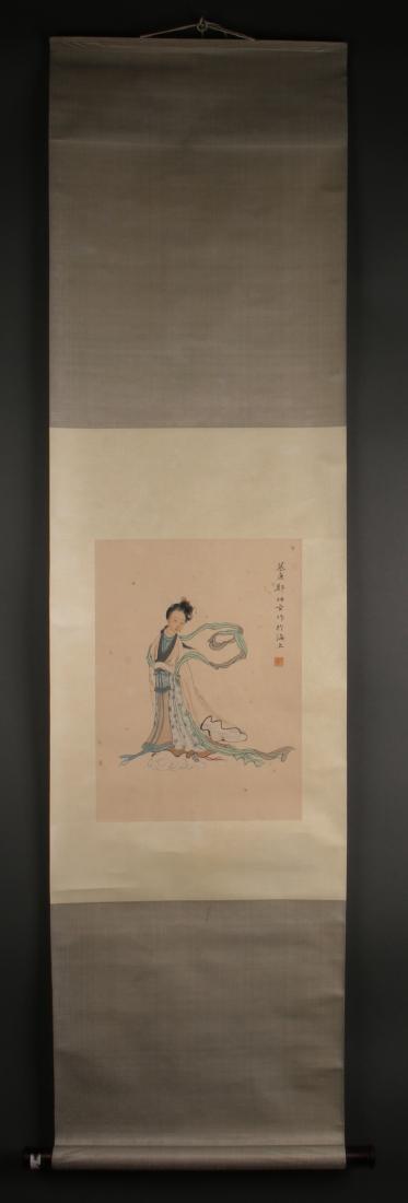 SCROLL OF ROBED WOMAN: Scroll Of Robed Woman: A women wears flowing robes that are gently being carried by the wind behind her. They are painted in intricate patterns of fabric, and she wears hair ornaments. Calligraphy an