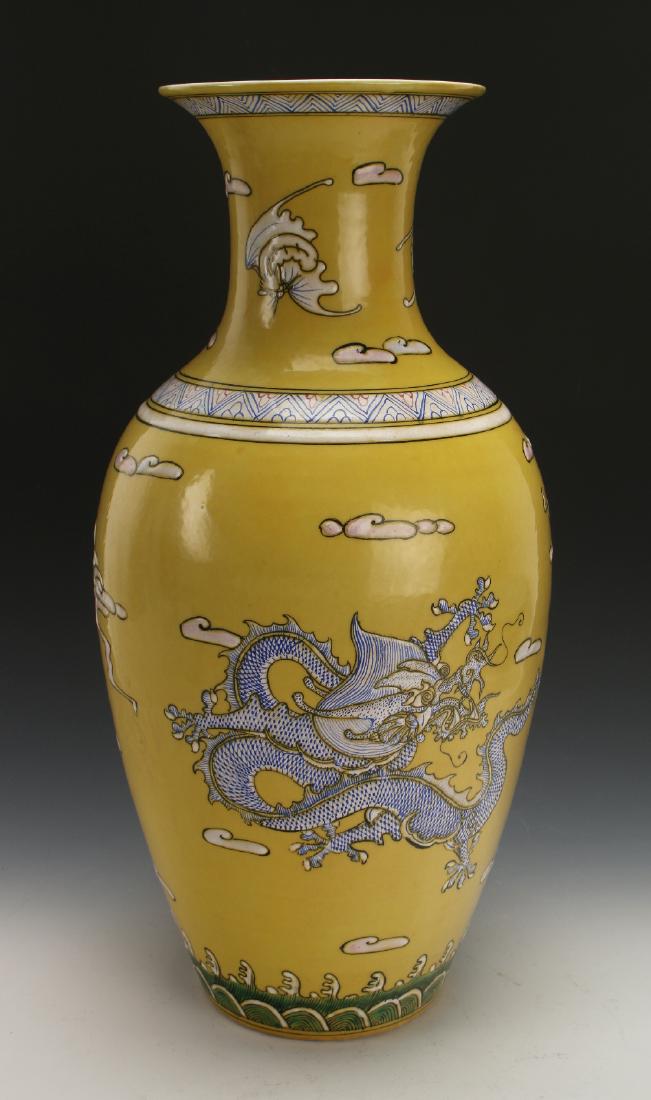 YELLOW VASE WITH DRAGONS & BATS: Yellow Vase With Dragons & Bats: The top has a diapered border in blue and white above bats flying among clouds on the neck. The shoulder has a geometric border. The body of the vase shows two dra