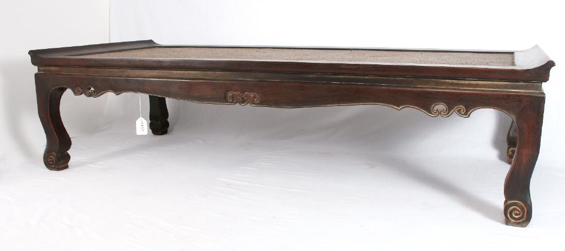 ZITAN DAY BED: Zitan Day Bed: Zitan day bed with a caned seating area, carved and scalloped edge, and scrolled feet. 79 1/2" X 35 1/4" X 20 1/2" $1000 - $1500