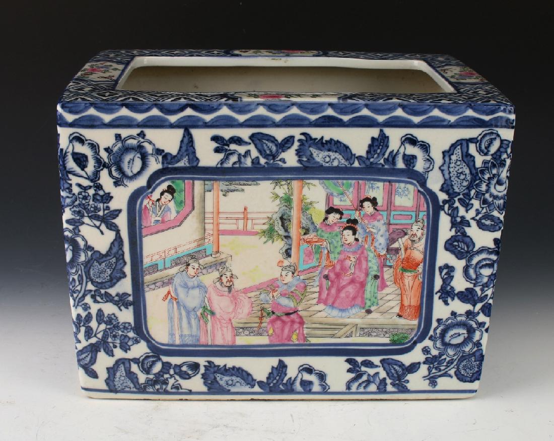 CHINESE FLOWER POT: Chinese Flower Pot: A flower pot in blue and white with reserves of domestic scenes on front and back surrounded by blue flowers and leaves. The top rim has four reserves of butterflies and flowers on