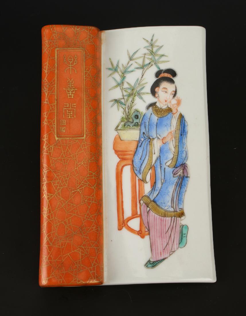 PORCELAIN WRIST REST: Porcelain Wrist Rest: This porcelain wrist rest is shaped like an open book and is made to keep one's hand from smearing artwork while painting. The "book's" spine has a perforated pattern.