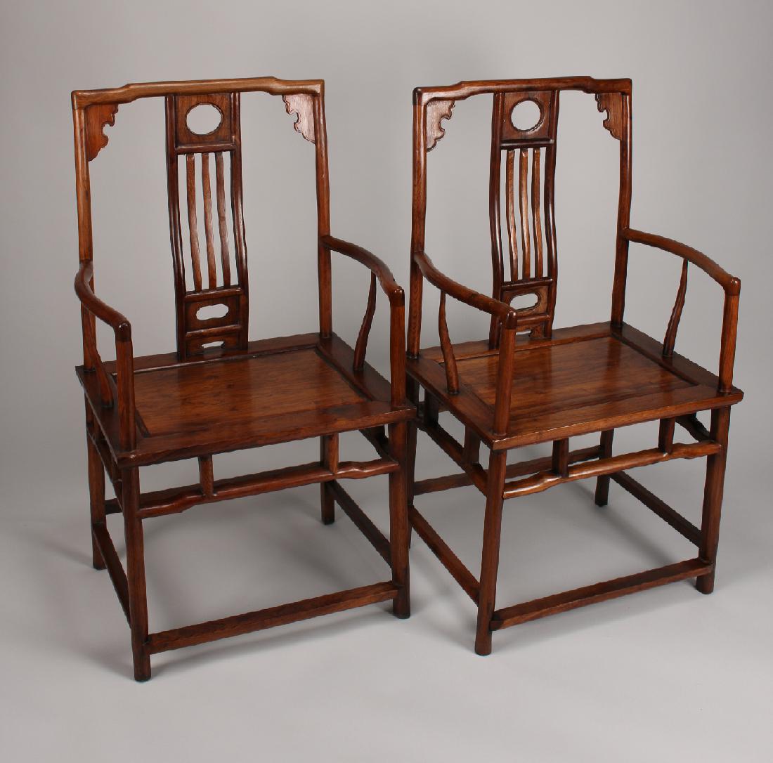 PAIR OF HUANGHUALI ARM CHAIRS: Pair Of Huanghuali Arm Chairs: Paneled seats, teardrop shaped legs, beaded and scalloped corners, very highly figured, and mortise and tenon construction. 18" X 23 1/2&