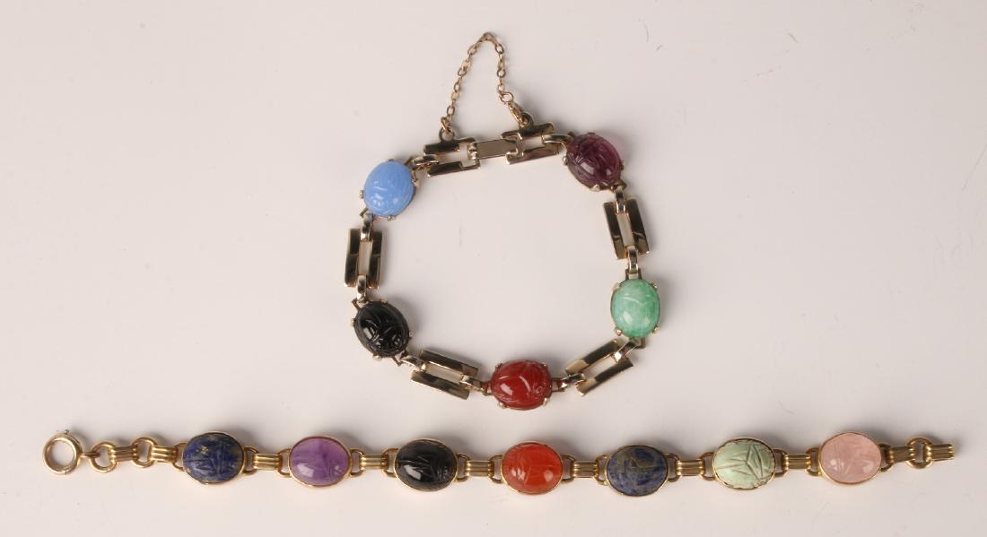 TWO GOLD SCARAB LINK BRACELETS: Two Gold Scarab Link Bracelets: One marked 12k with seven scarabs, the other is unmarked with five scarabs. Provenance: