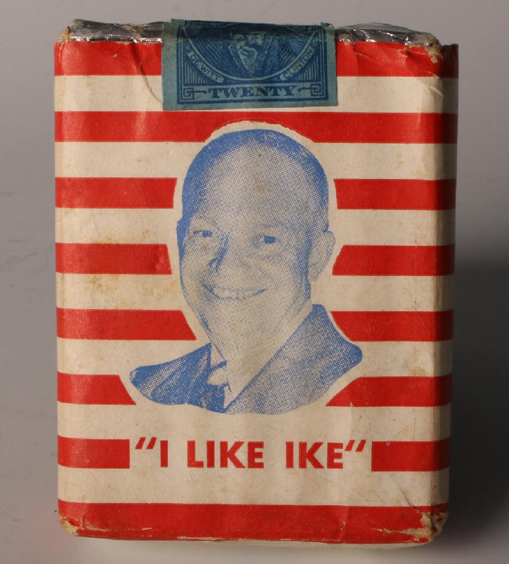 UNOPENED PACK OF 'I LIKE IKE' CIGARETTES: Unopened Pack Of 'I Like Ike' Cigarettes: An unopened pack of cigarettes with white and red stripes that says "Eisenhower for President" with a photo of Eisenhower and "I Like Ike"