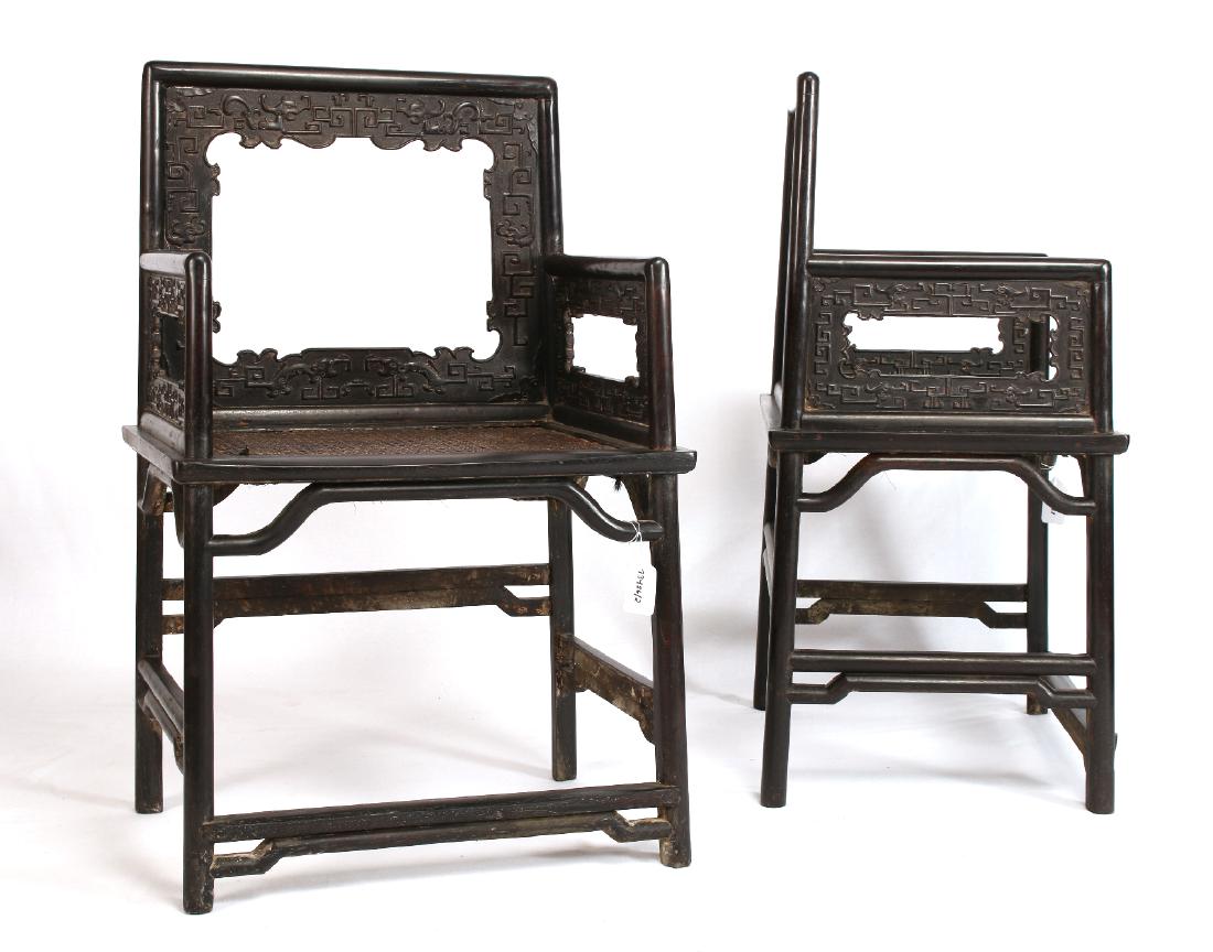 PAIR OF ZITAN ROSE CHAIRS: Pair Of Zitan Rose Chairs: Two Zitan open back rose chairs carved with geometric shapes and creatures. 23 1/2" X 18" X 37" $600 - $900 Ship