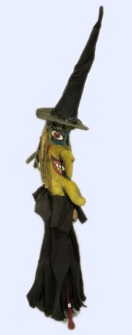 HAND MADE WICKED WITCH STICK PUPPET: Hand Made Wicked Witch Stick Puppet: A hand made wicked witch puppet with green ribbon hair and hand painted features. She wears a tall wrapped witches hat and tattered robes.