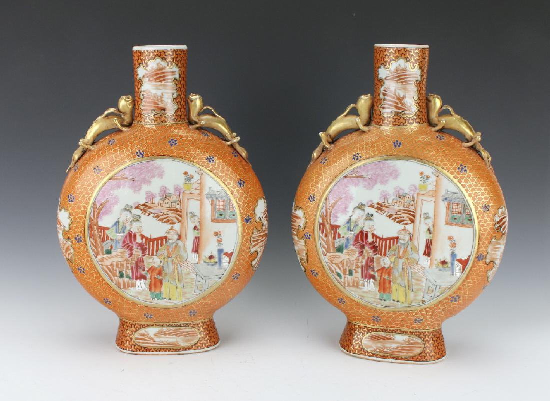 PAIR OF MOON FLASKS WITH VILLAGE SCENES: Pair Of Moon Flasks With Village Scenes: Moon flasks with three dimensional gold creatures sitting on the shoulders. Circular reserves in the center of domestic life, and irregularly shaped reserves o
