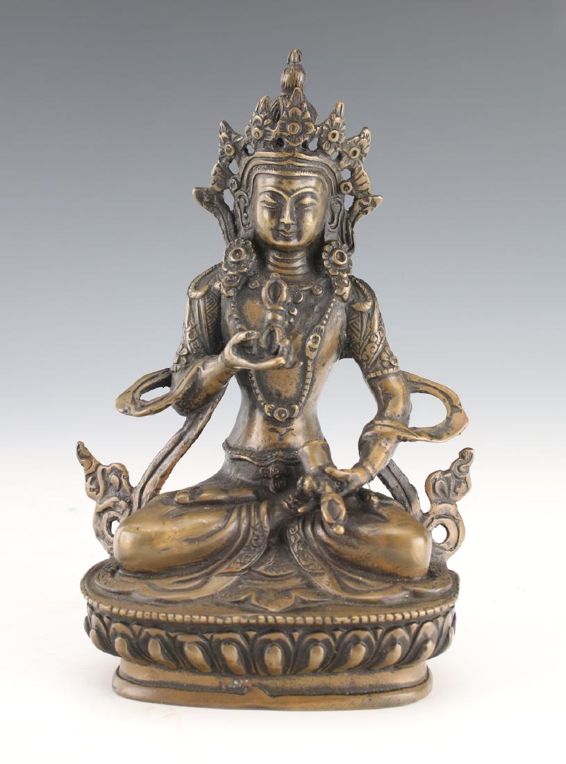 BRONZE BUDDHA: Bronze Buddha: Bronze Buddha is holding a bell with five pronged vajra handle in one hand and a vajra weapon in the other. Marked on the bottom. 4" X 2" X 5 3/4&quo