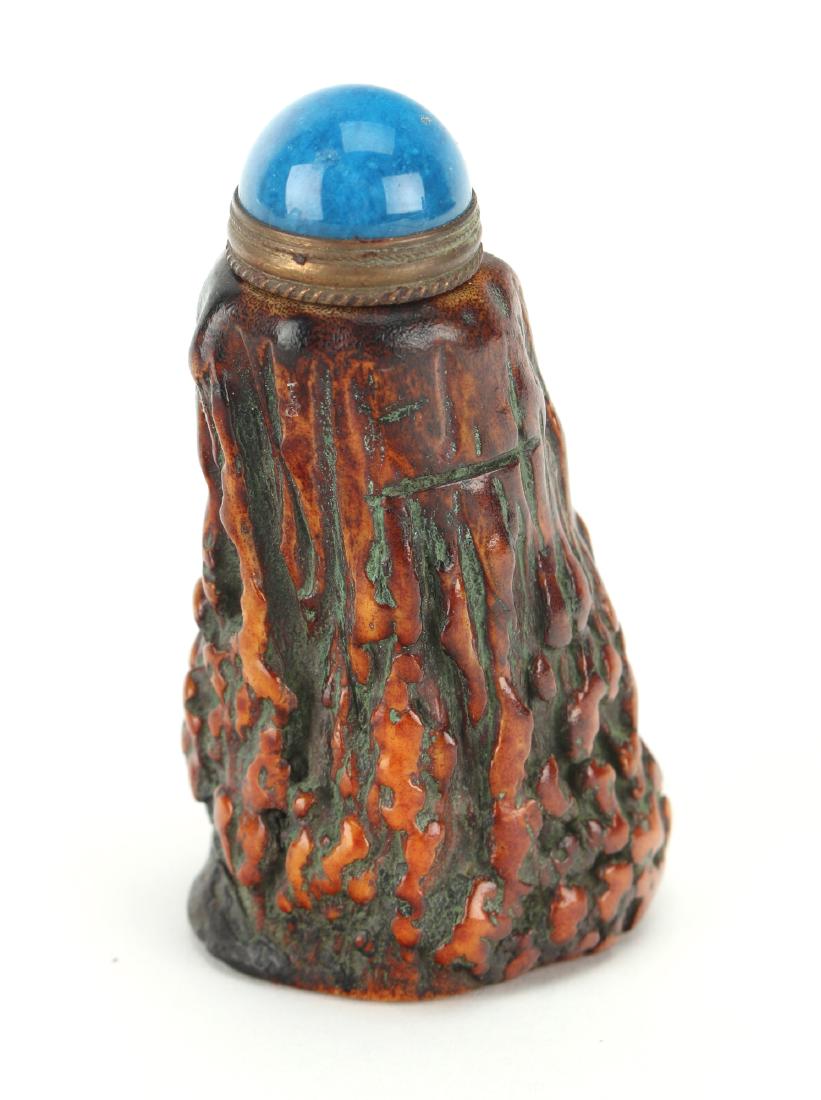 OX HORN CARVED TREE SHAPED SNUFF BOTTLE: Ox Horn Carved Tree Shaped Snuff Bottle: Ox horn snuff bottle carved to mimic the bark of a tree. The stopper is in turquoise glass. 3" $200 - $400 S
