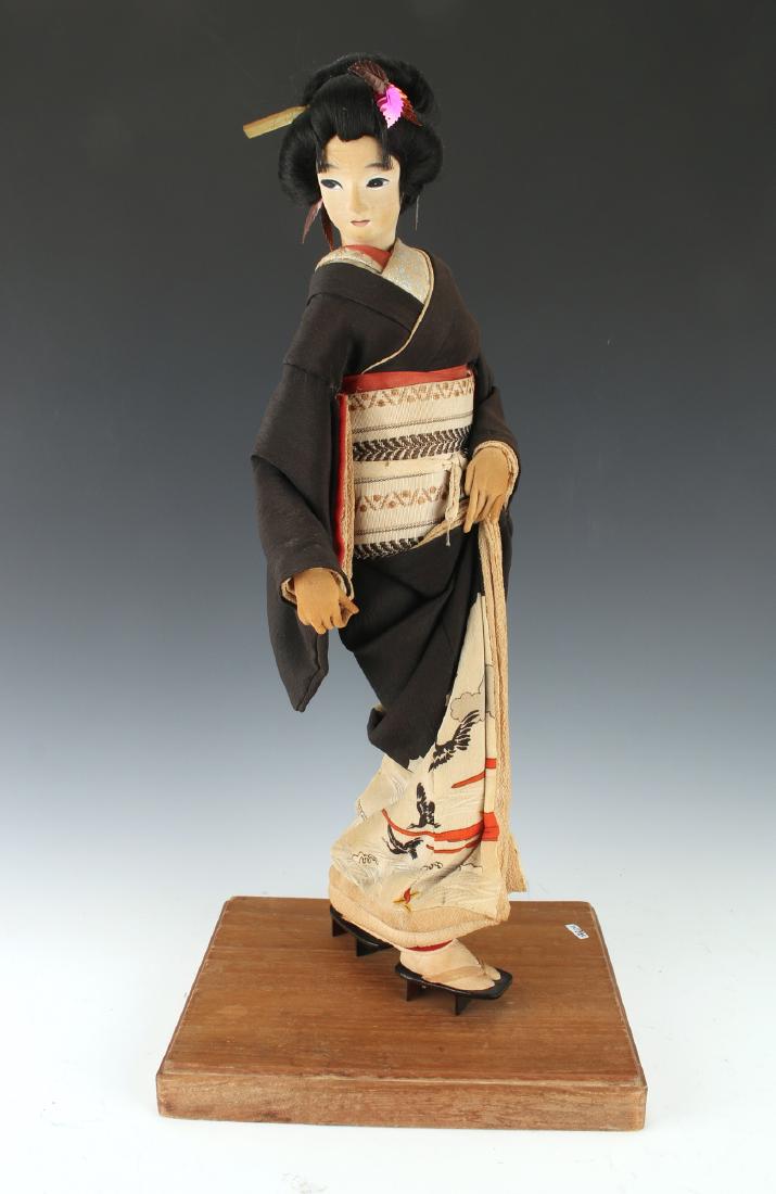 GRACEFUL GEISHA DOLL: Graceful Geisha Doll: She is shown picking up the hem of her kimono in one hand as she steps forward on her wooden clogs. 18" tall $100 - $200 Shippi