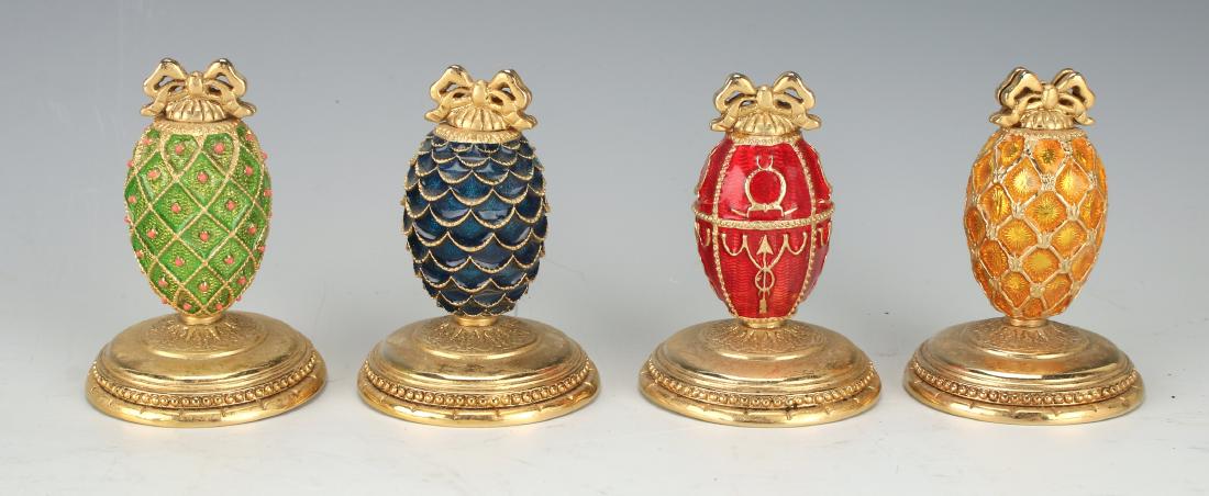 FOUR FABERGE EGG PLACE CARD HOLDERS: Four Faberge Egg Place Card Holders: Four different color Faberge egg place card holders with a slit on top. Marked Faberge on the bottom. 2" X 1 1/2" $30