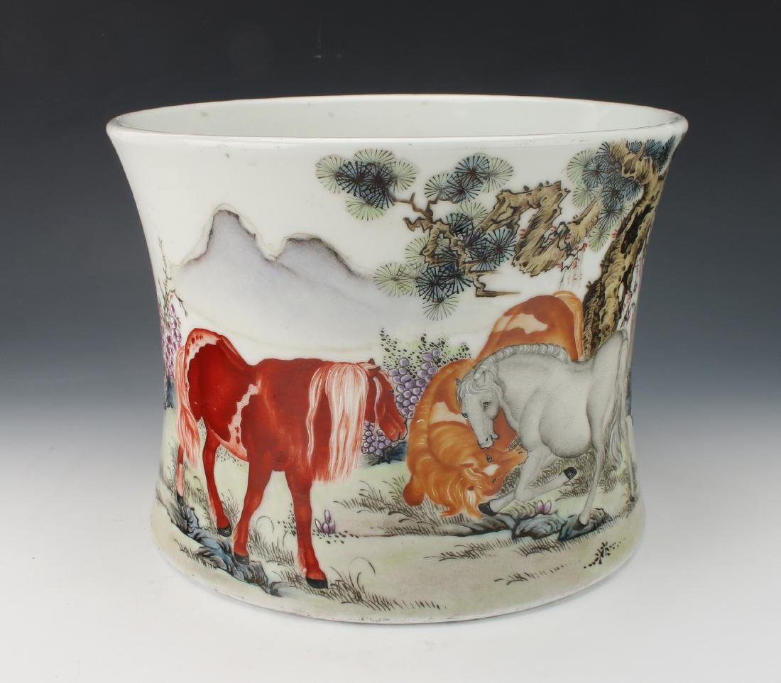 REPUBLIC PERIOD HORSE BRUSH POT: REPUBLIC PERIOD HORSE BRUSH POT: Cylindrical brush pot with a slightly concave waist. Calligraphy and artist mark on back, three horses cavort in a field on the front. The scene is in spring time with