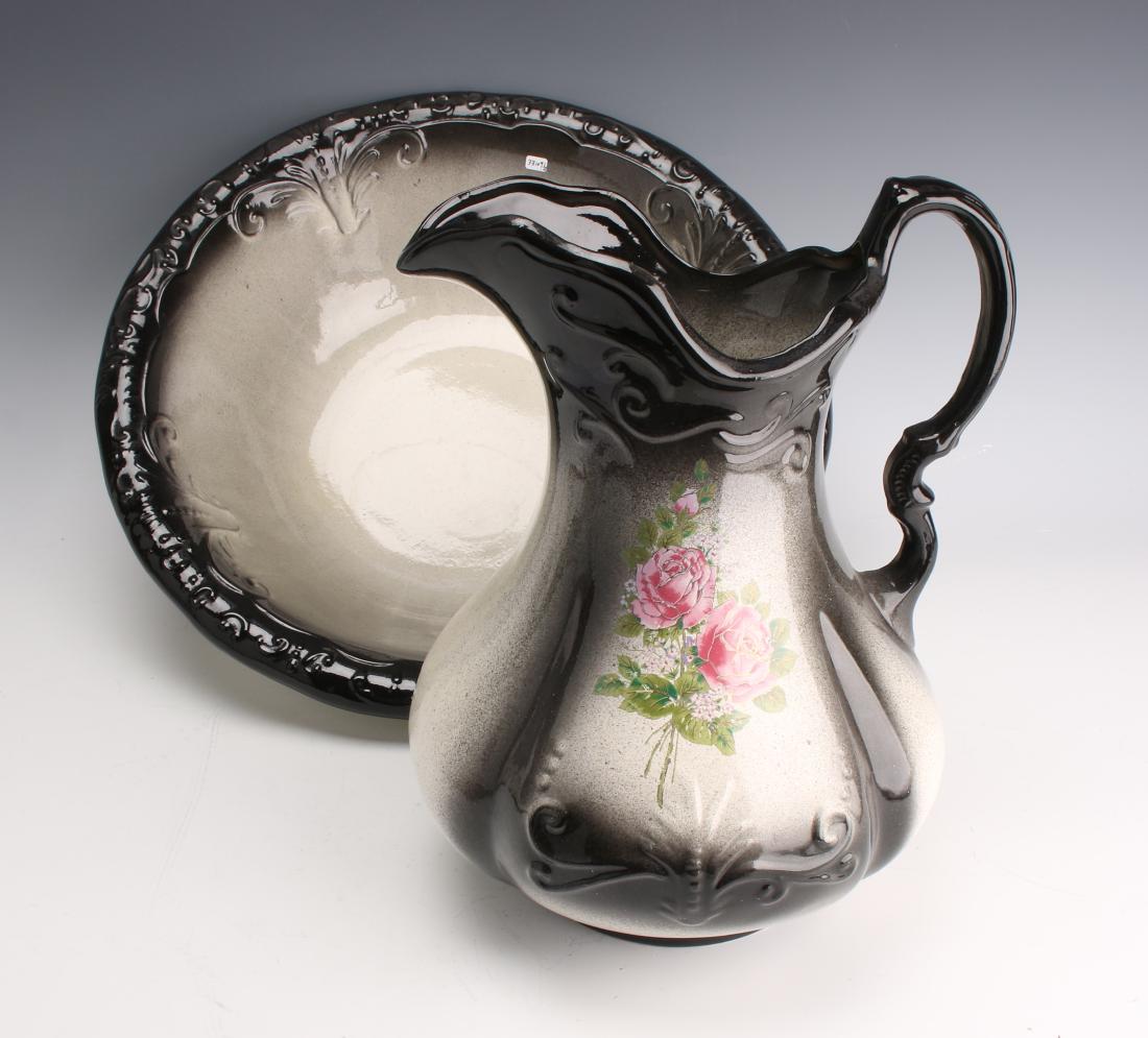 IRONSTONE WASH BASIN W PITCHER: IRONSTONE WASH BASIN W PITCHER: Ivory with gradations of black and a pink rose pattern on the body of the pitcher. Marked Ironstone 1890 England on bottom. 11 1/2" X 8&q