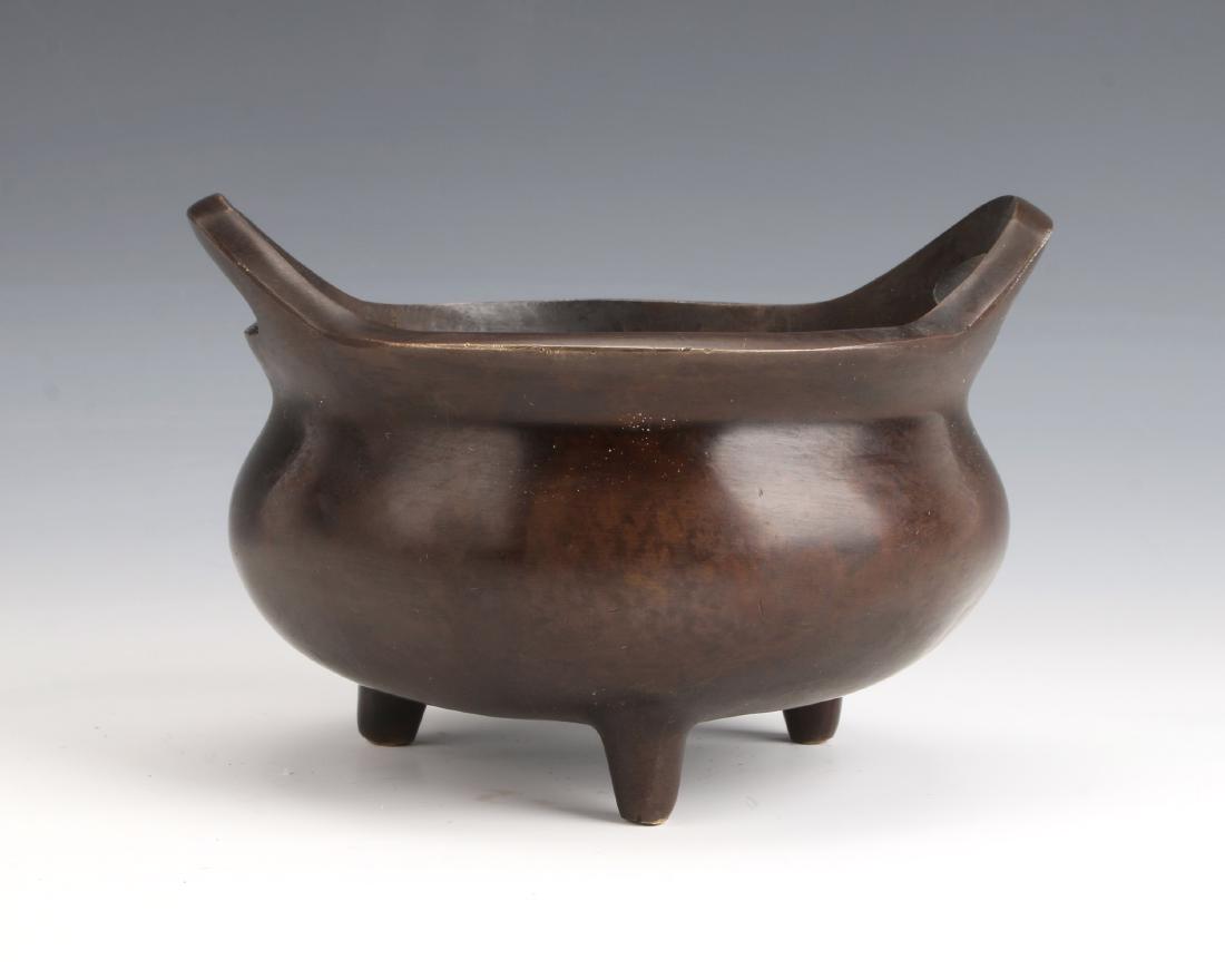 TRIPOD BRONZE CENSER: TRIPOD BRONZE CENSER: Tripod censer with open loop handles. Marked on the bottom. 4 1/2" X 2 1/2" $100 - $200 Shipping: W